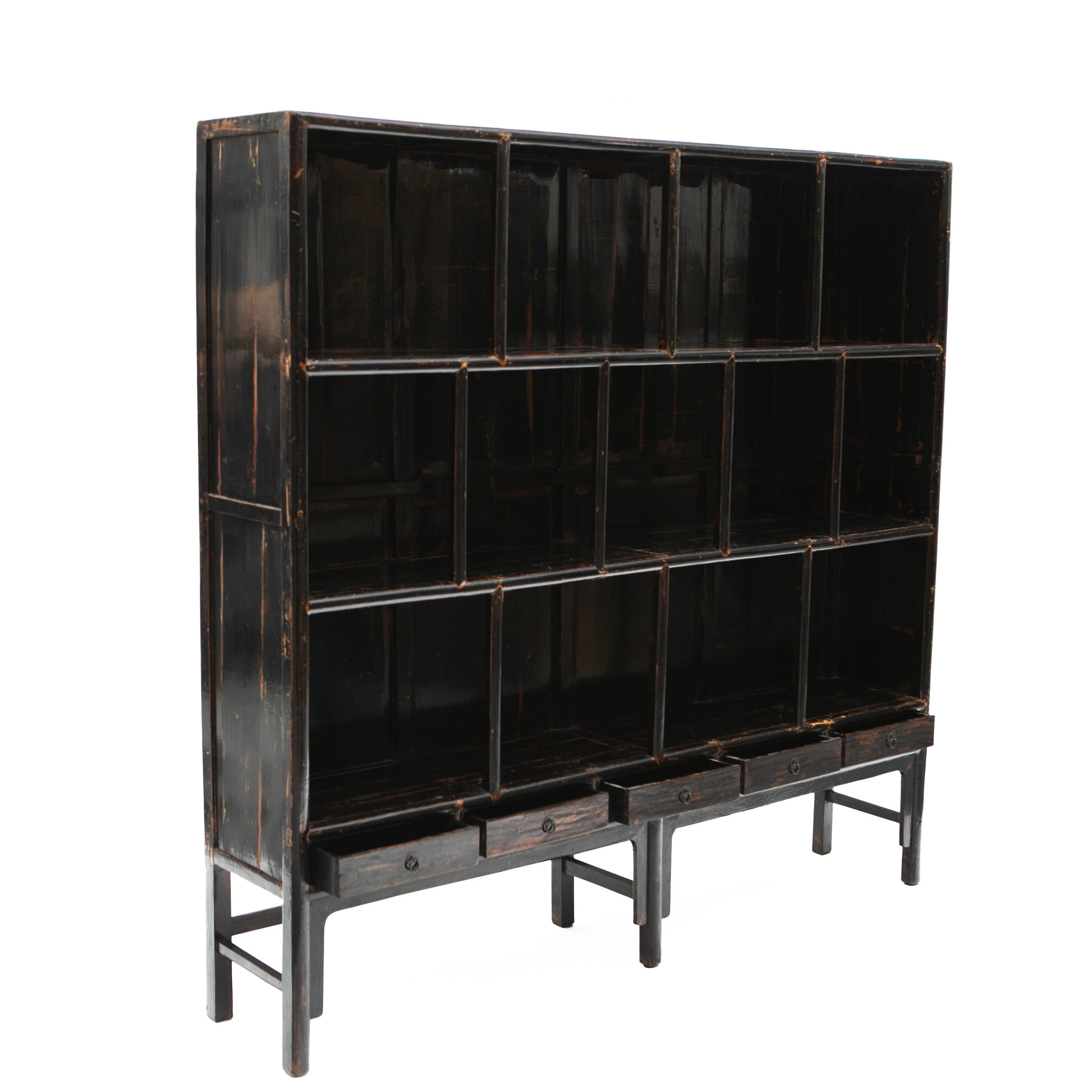 Large bookcase with original black lacquer, showcasing a beautiful age-related patina, accentuated by a clear lacquer surface finish.
The bookcase features three shelves with 'lattice' fronts, originally used for storing paper rolls for calligraphy,