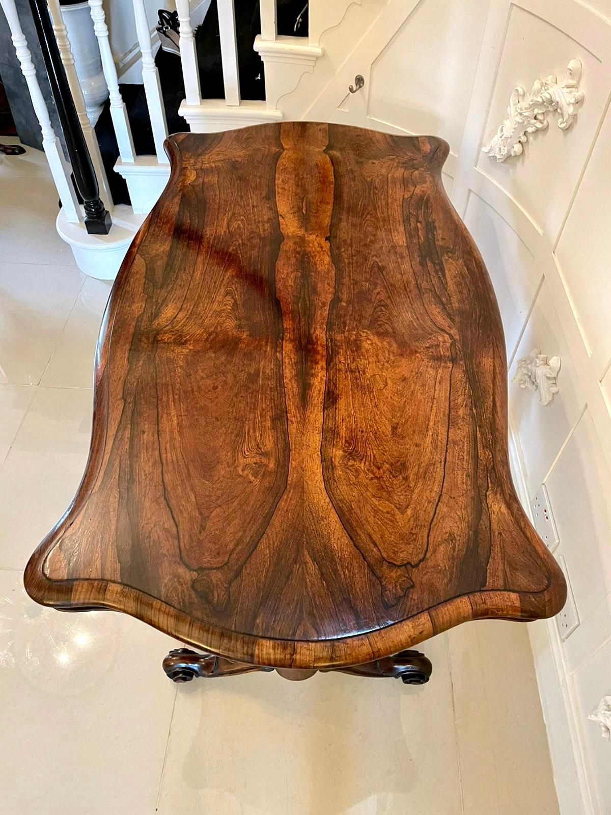 Large quality antique Victorian carved rosewood centre table having a quality rosewood serpentine shaped top with a moulded edge, serpentine shaped frieze with a beaded edge supported by solid rosewood shaped columns. It stands on beautifully shaped