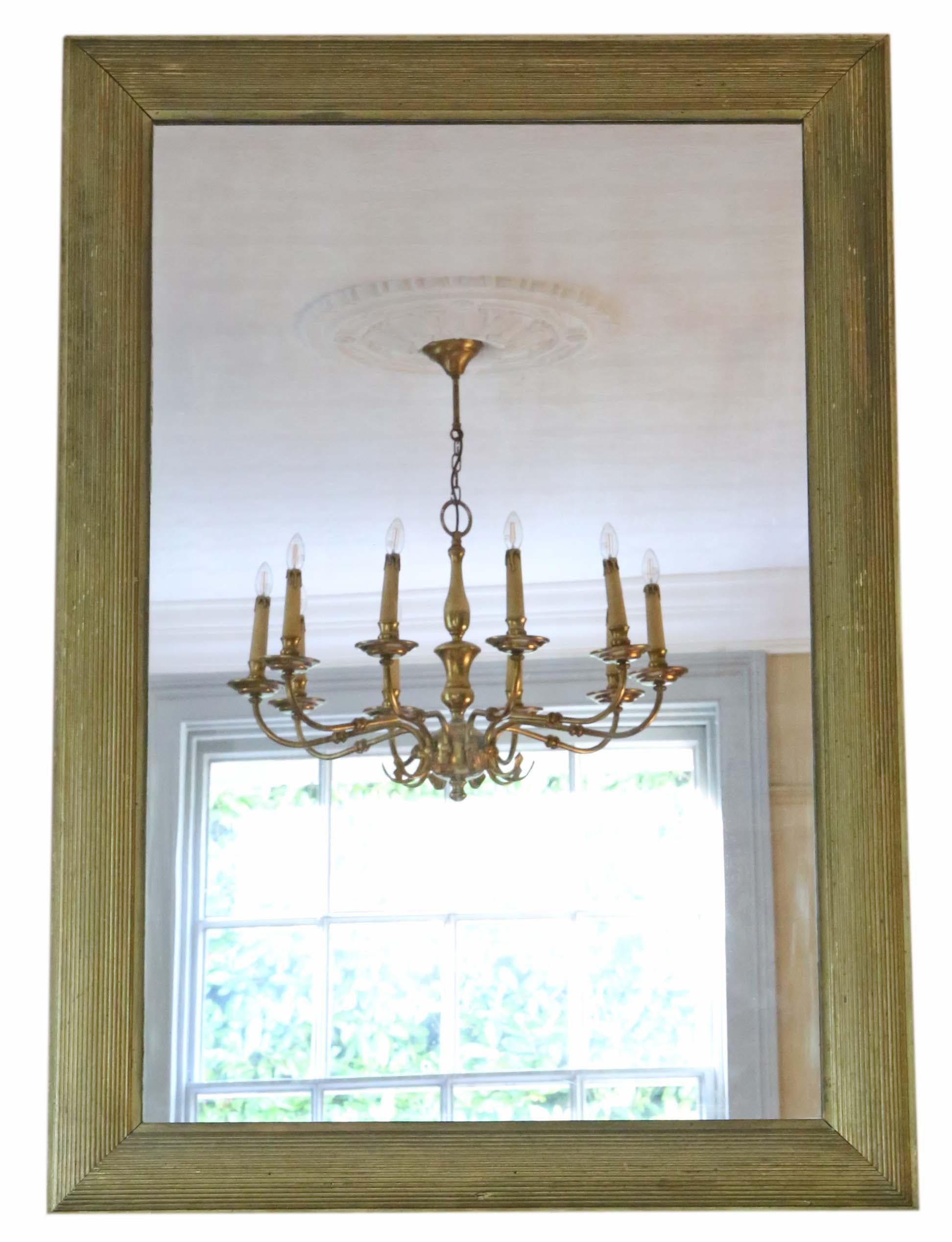 Antique large gilt overmantle or wall mirror from the Art Deco period, dating approximately from 1900-1920. It exudes lovely charm and elegance, featuring its original finish with minor losses and touching up in various areas.

This mirror stands