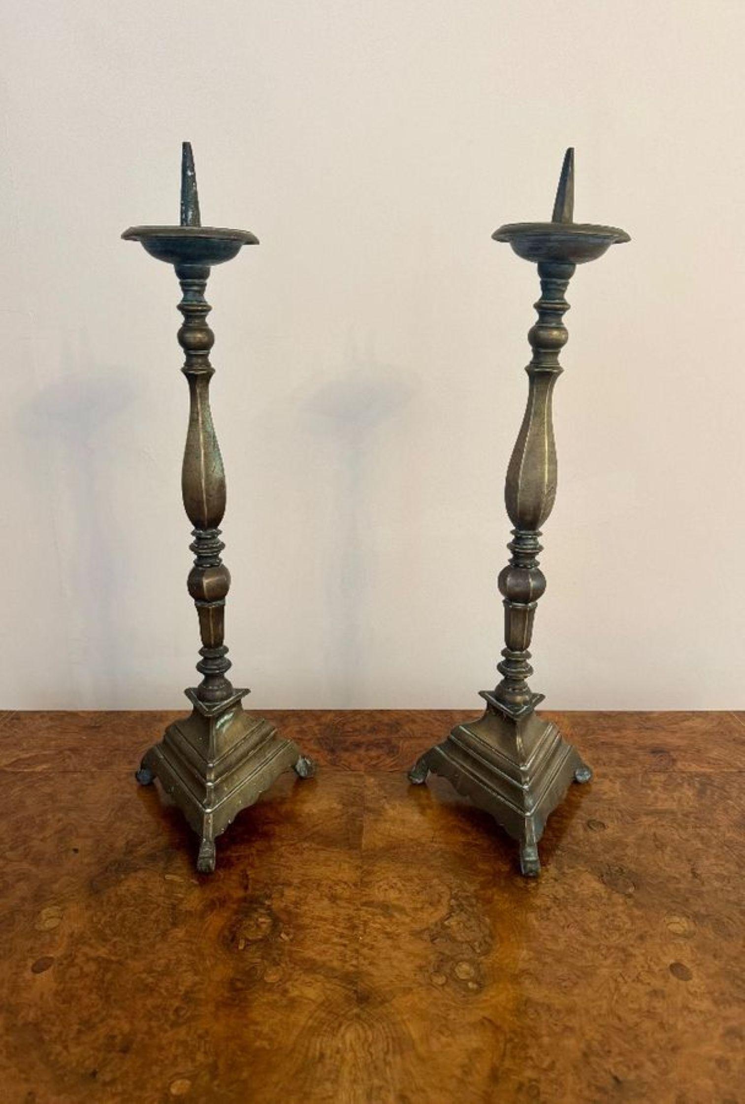 Large quality pair of antique Regency brass pricket candlesticks, having a quality pair of antique pricket candlesticks with an upper circular plate with a pricket spike to the centre above slender tall baluster supports raised on triform bases