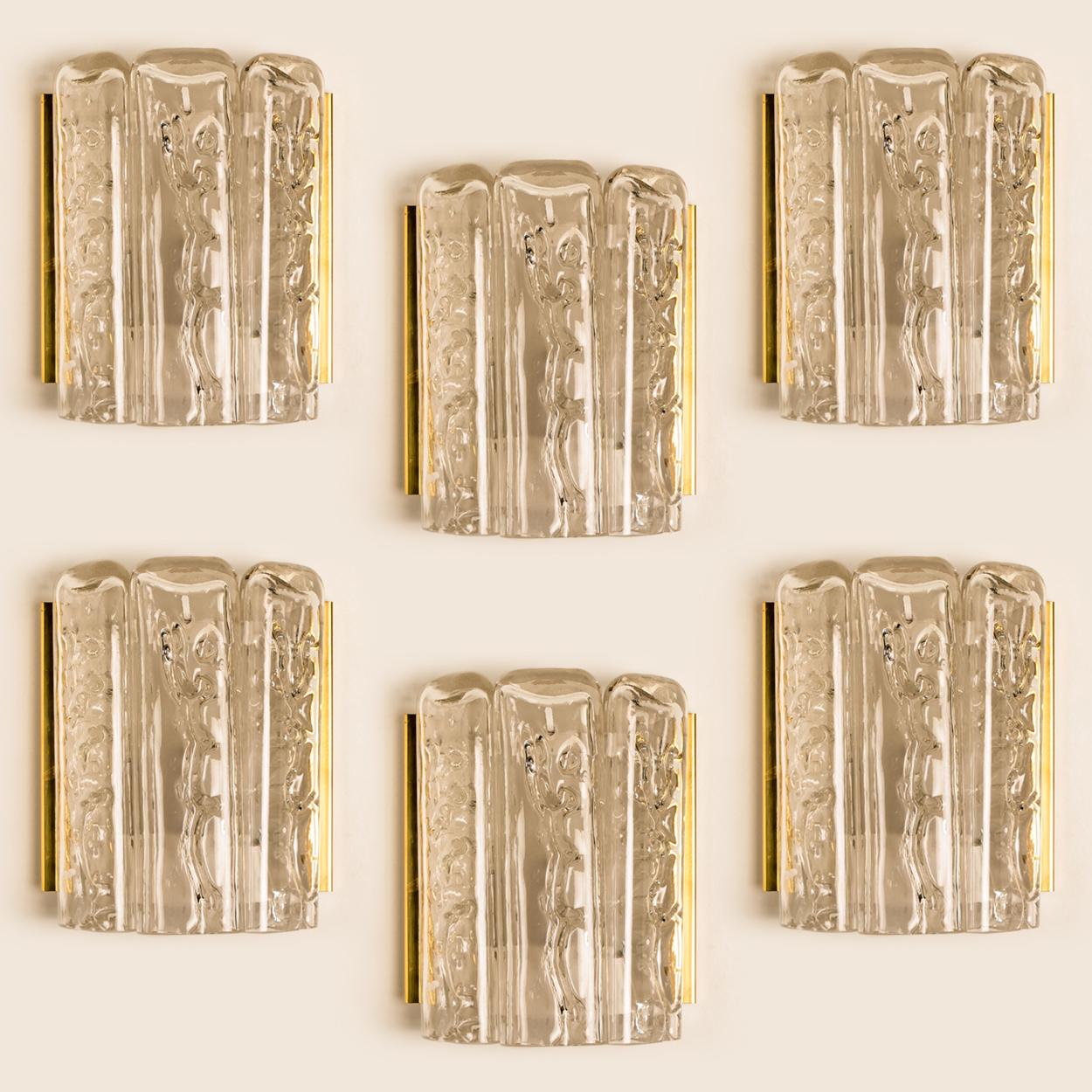 This set of blown wall sconces date from the 1960s and were created by the iconic firm of Doria Leuchten in Germany. They are fabricated with a backplate in white and brass and with two molten-glass, flat tubular prisms. High-end pieces

Measures: