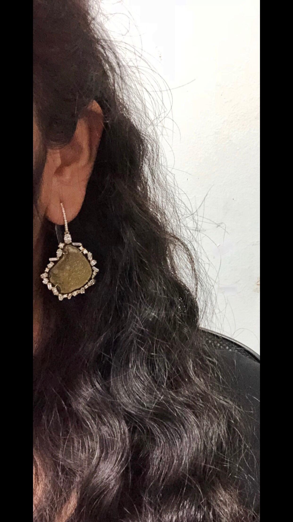 Large quartz geode dangle earrings in 18k yellow gold set with a free form halo of various shaped diamonds and round diamonds in the bell. The earrings have a total of approximately 4.15 carat total weight in diamonds. Larger diamonds in the halo