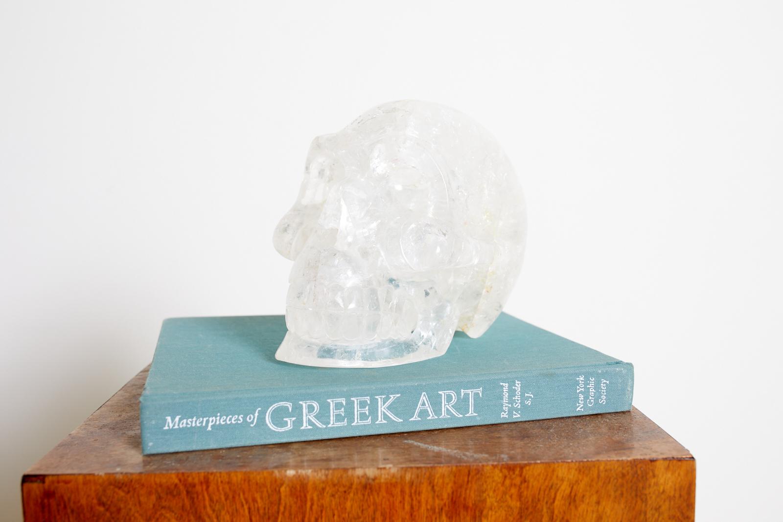 Fascinating large skull sculpture handcrafted from quartz rock. Rare life-size sculpture weighing approximately 11 pounds. Beautifully crafted with small red and yellow iron inclusions that add to its mystique. From an estate in Hollywood, CA.