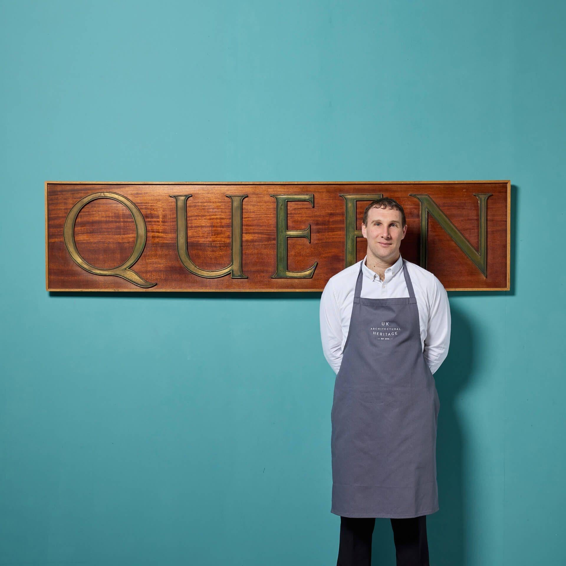 A large reclaimed ‘Queen’ wall hanging sign dating to the early 20th century. Bold and stylish cast bronze letters are mounted onto a smooth mahogany board to create a striking Edwardian style plaque perfect for a castle or Manor House. This unique