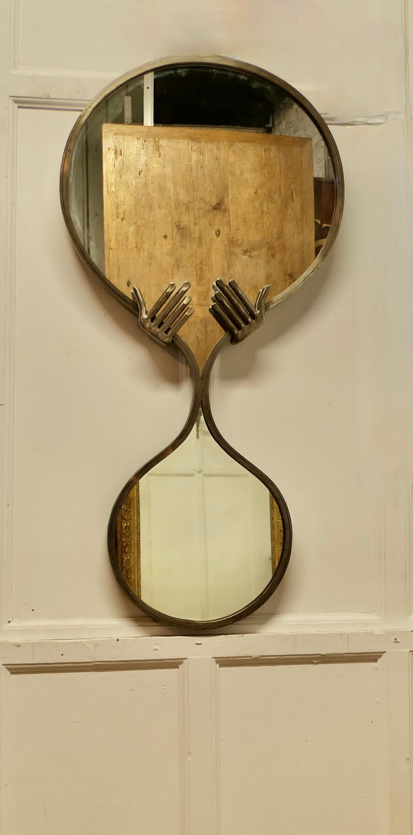 Large Quirky Mid Century One Off Designer Wall Mirror 

A figure of 8 frame set with hands, the mirror is a one off design, it is made in metal, it is in good used condition 
The mirror is 48” tall, and 24” wide
TCS28