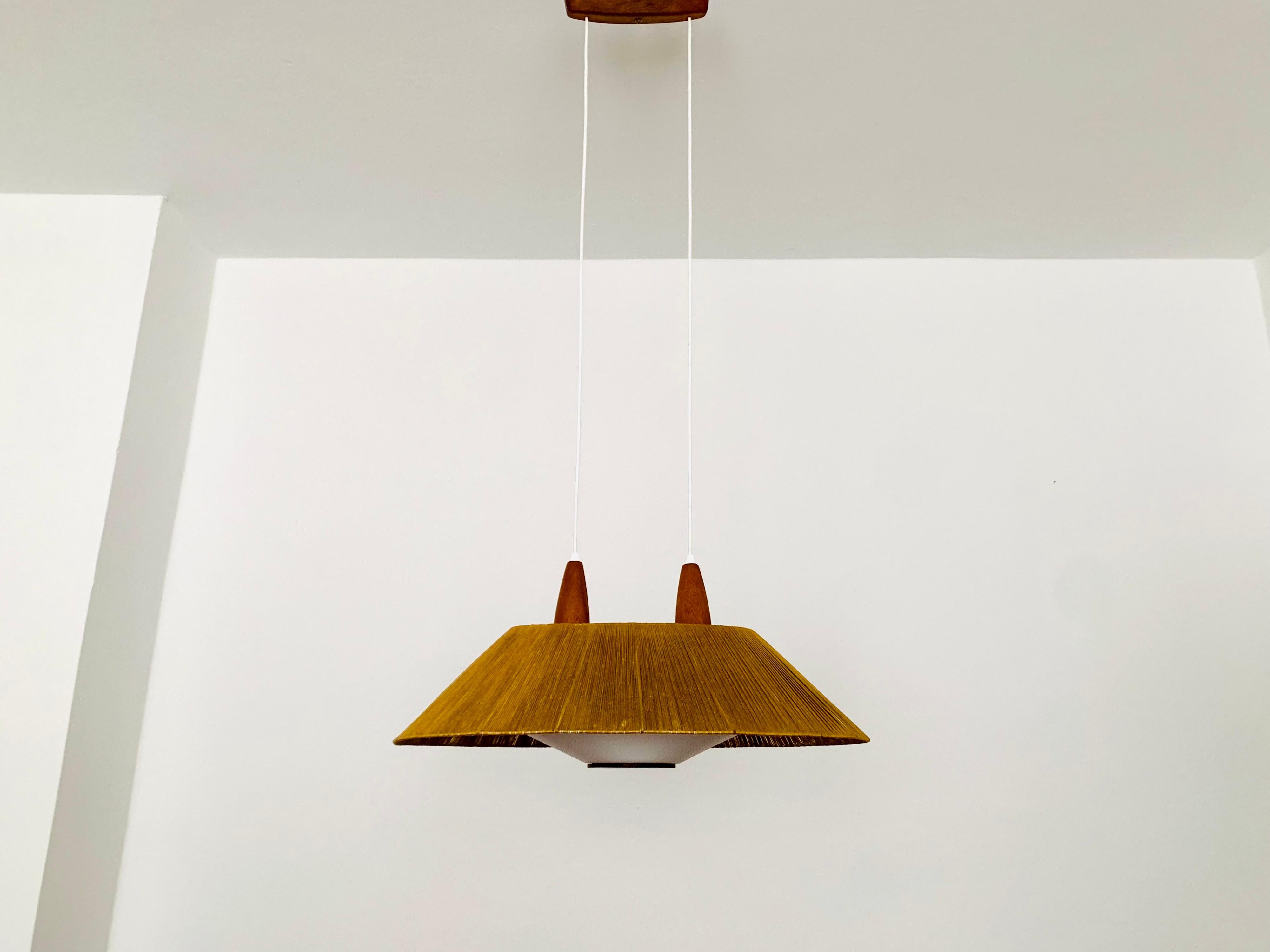 Exceptionally beautiful and large pendant lamp from the 1960s.
The design is very unusual.
The shape and the materials create a warm and very pleasant light.
The teak details are beautifully shaped.

Condition:

Very good vintage condition