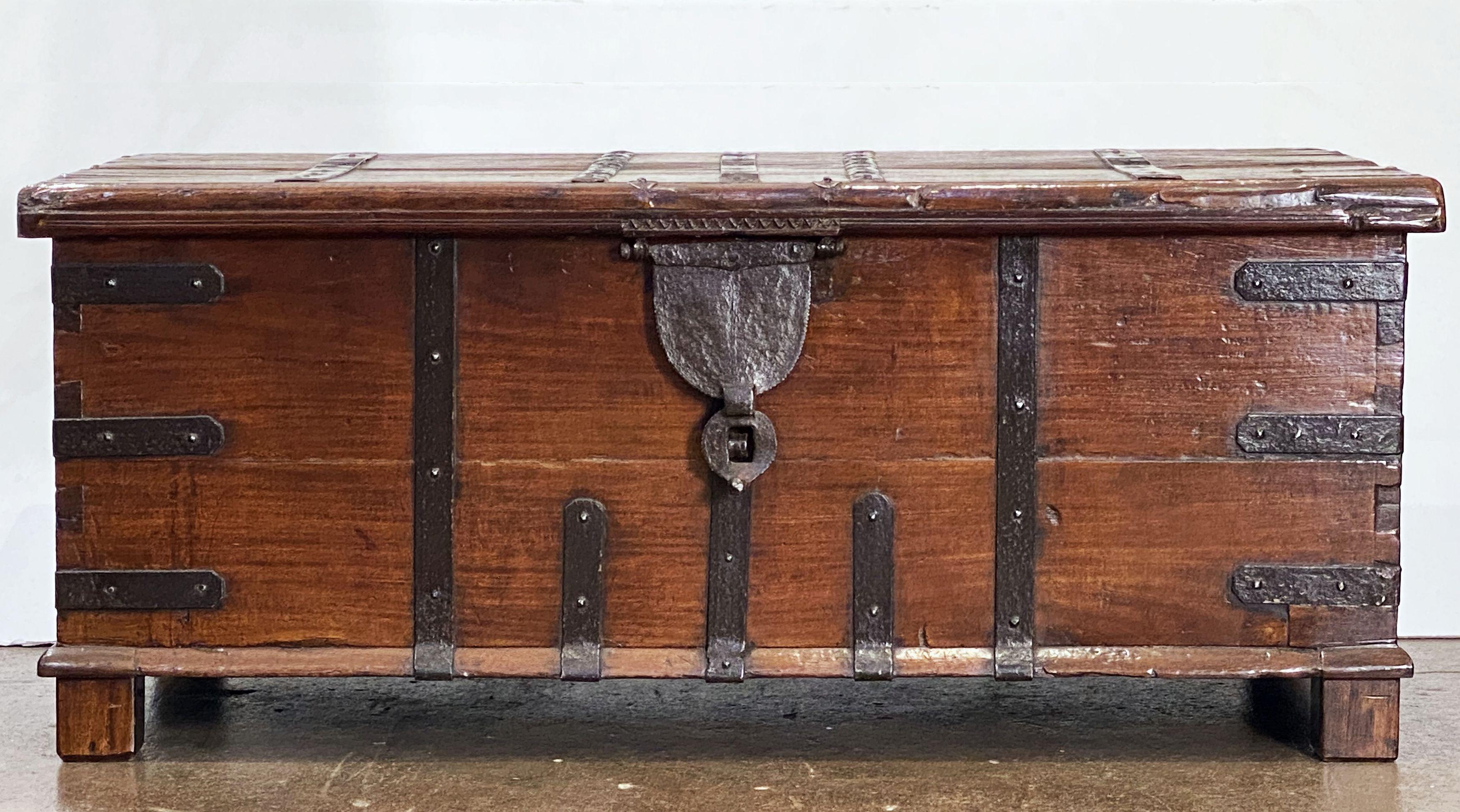 A handsome large 19th century rectangular iron-bound wooden coffer box or Rajasthan trunk from British Colonial India (The Raj), c.1860, featuring a hinged top hatch with storage inside.

Traditionally used for patio storage in Indian havelis -