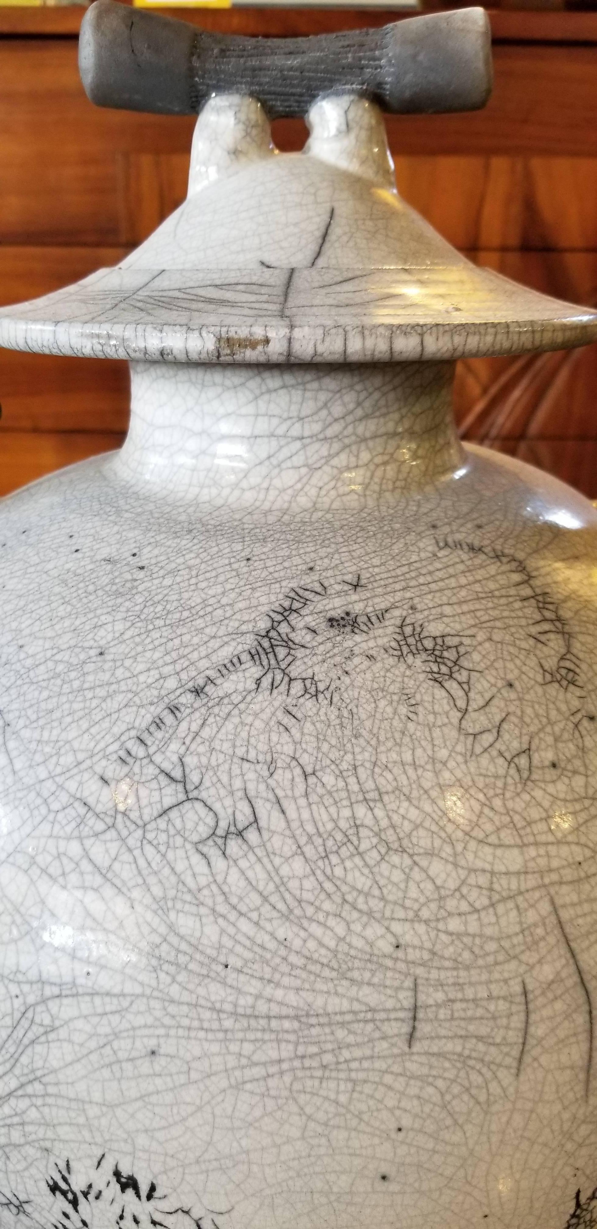 A beautiful two handled ceramic jar and lid with an extraordinary crackle glaze. Signed by artist. dated 1993.