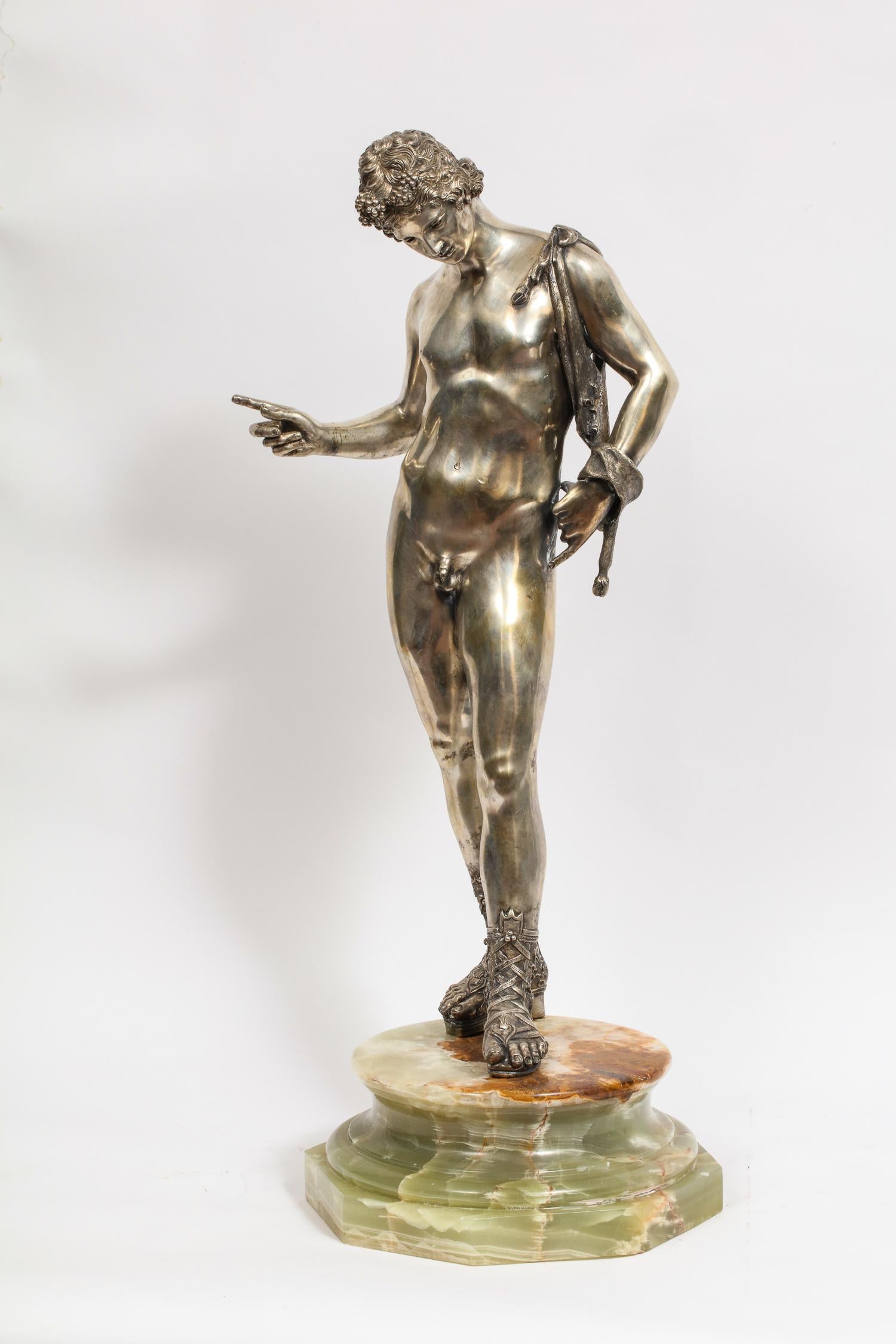 Large Italian silver figure / statue / sculpture of a male nude, Narcissus, after the antique,
early 20th century.

Depicting Narcissus with a goatskin over his shoulder, mounted on a green onyx pedestal, with national Italian mark to heel of