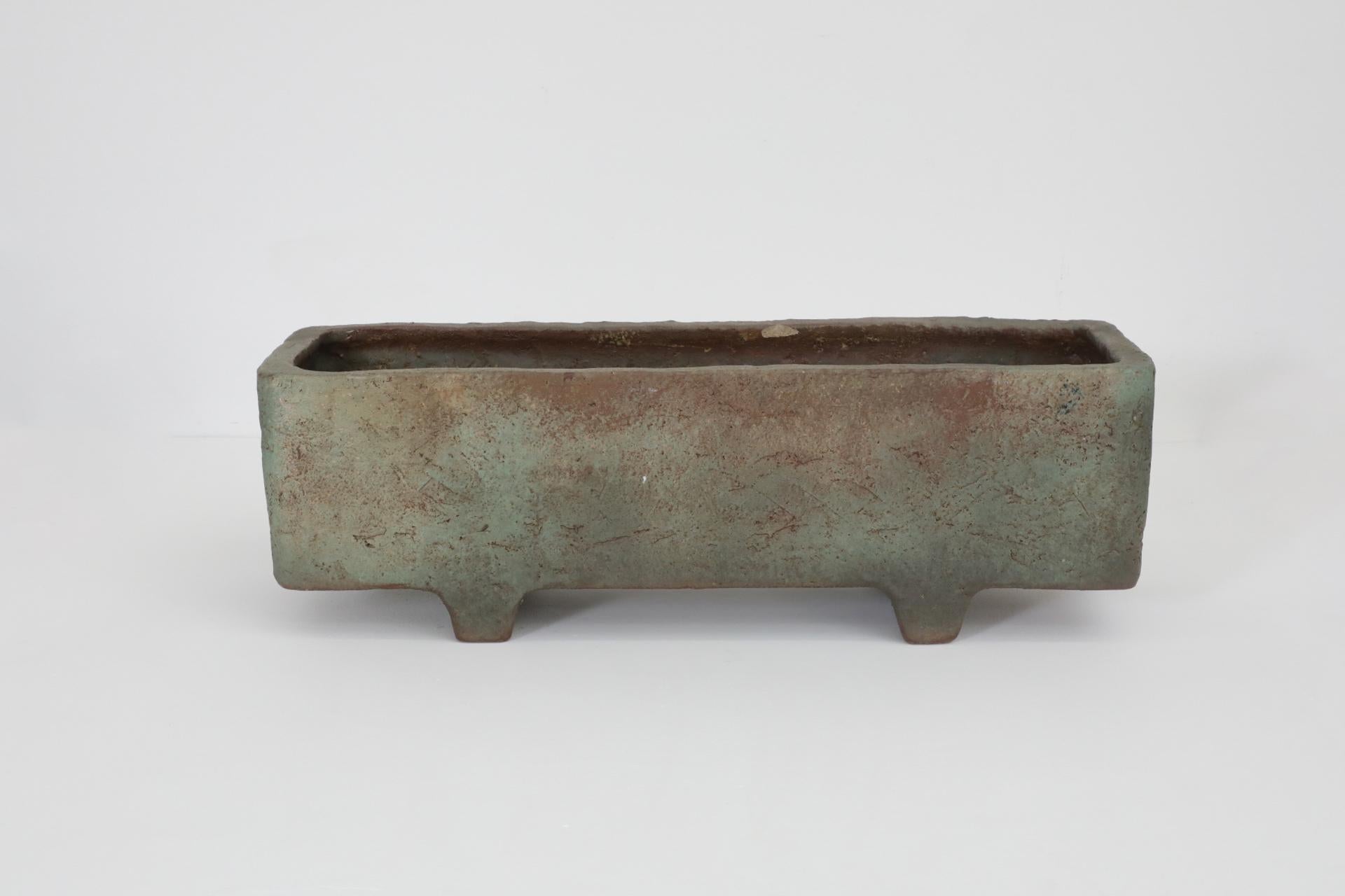 Mid-Century green and brown mottled Mobach planter. This signed heavy, large, linear ceramic trough floats on two full-width angled feet. We rarely see Mobach Ceramics this large! In original condition with visible wear consistent with its age and
