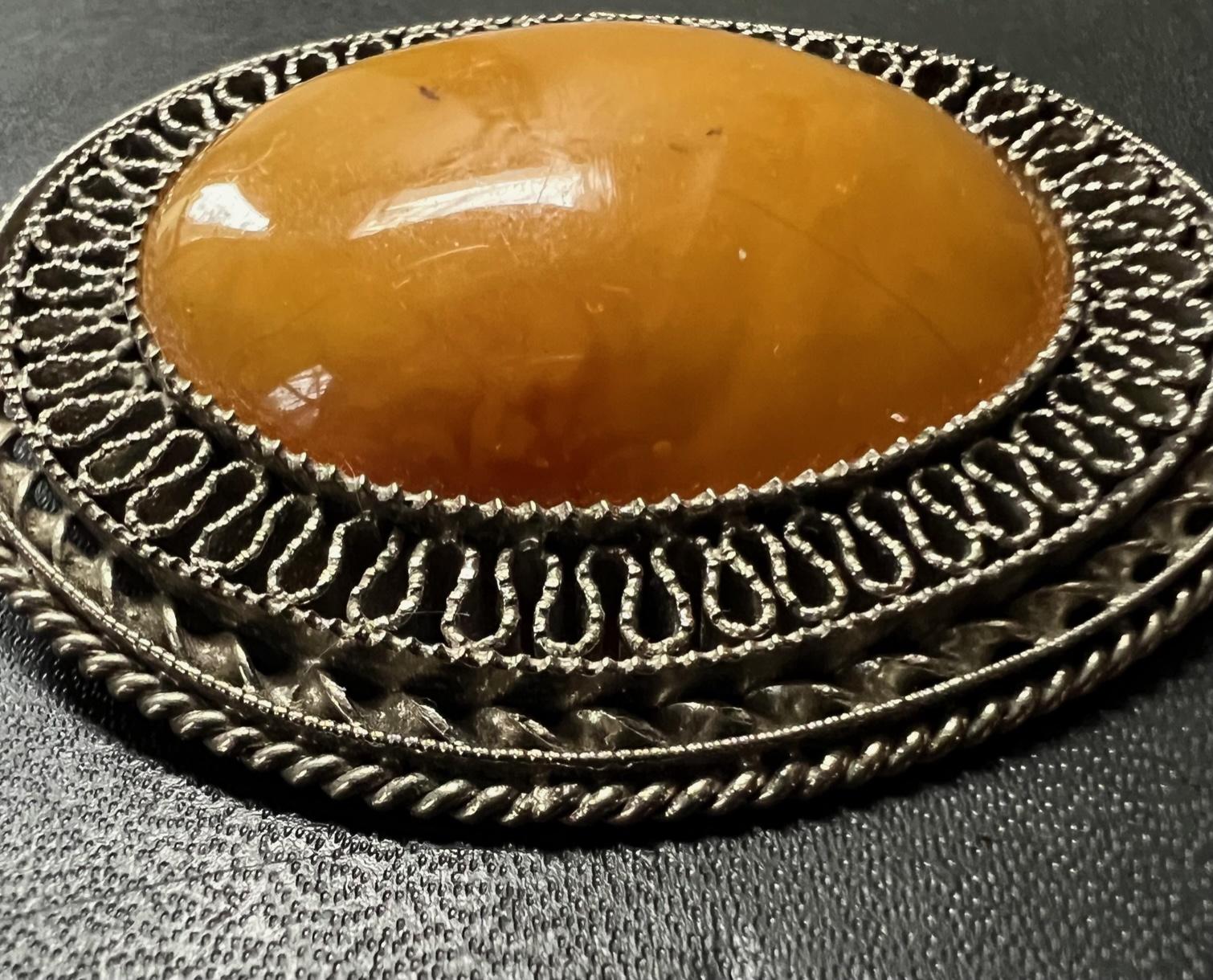 Rare solid amber brooch handcrafted in Latvia.  This unique ring was a part of my late grandmothers robust collection of amber jewelry.  She brought the pieces over on a boat while escaping Russian occupation in Latvia after World War 2.  This early