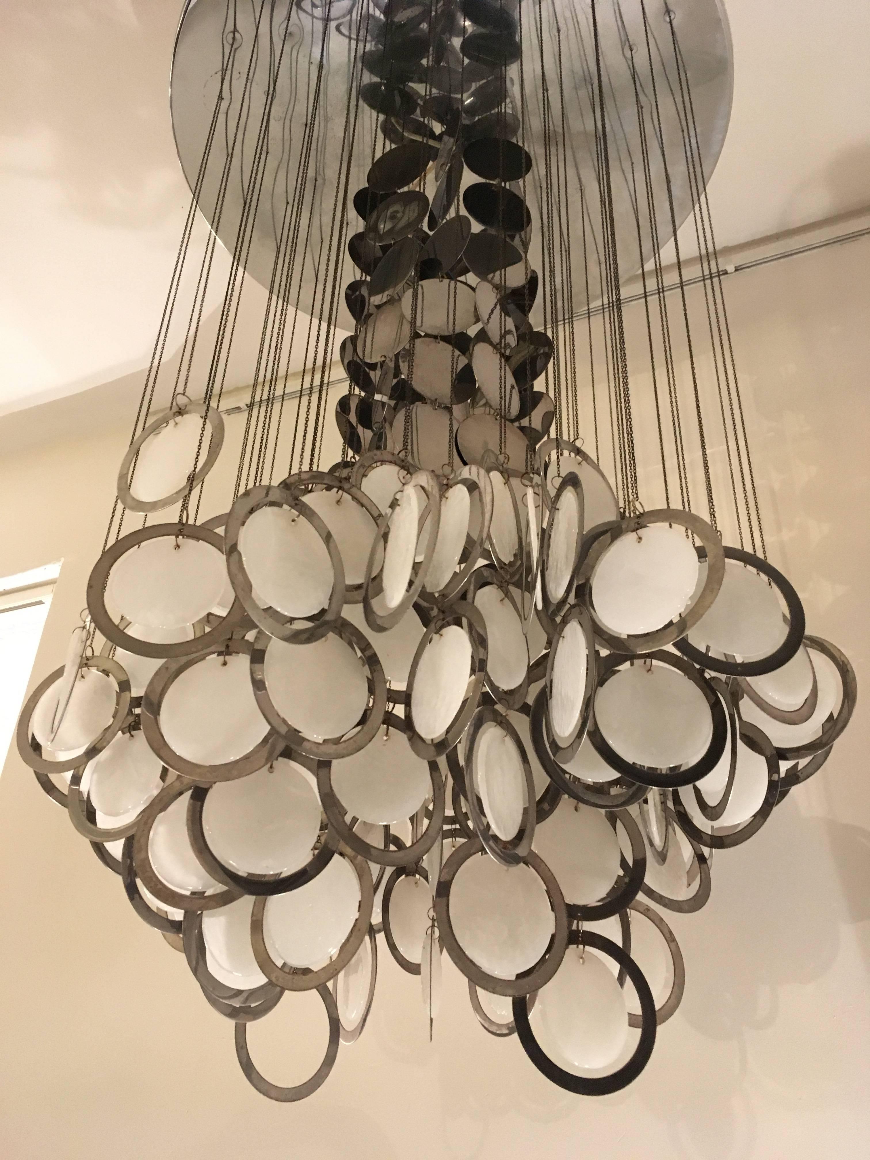 Large Murano hanging lamp with one cluster of white opal molded mother-of-pearl glass discs in a chromed ring. Attached by chains of small metal rings and one tier of metal chromed discs which gives a special sparkling light effect,hanging from a