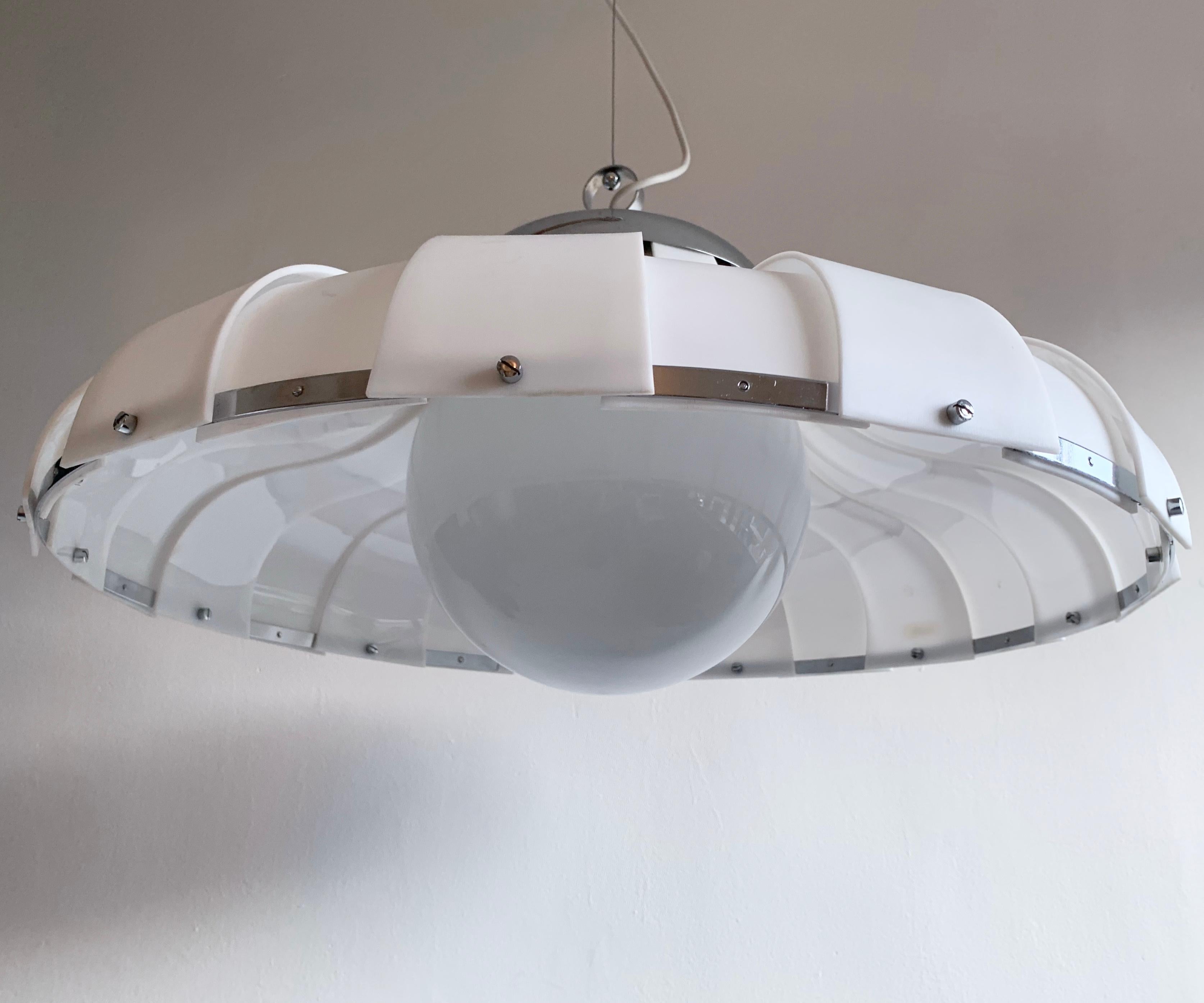 Very unusual, large, pendant lamp designed by Harvey Guzzini for Meblo, Italy in the 1970s. The shade is plastic, with chrome detailing and a spherical glass diffuser.

Dimensions (cm, approx): 
Diameter 63 
Height 27.