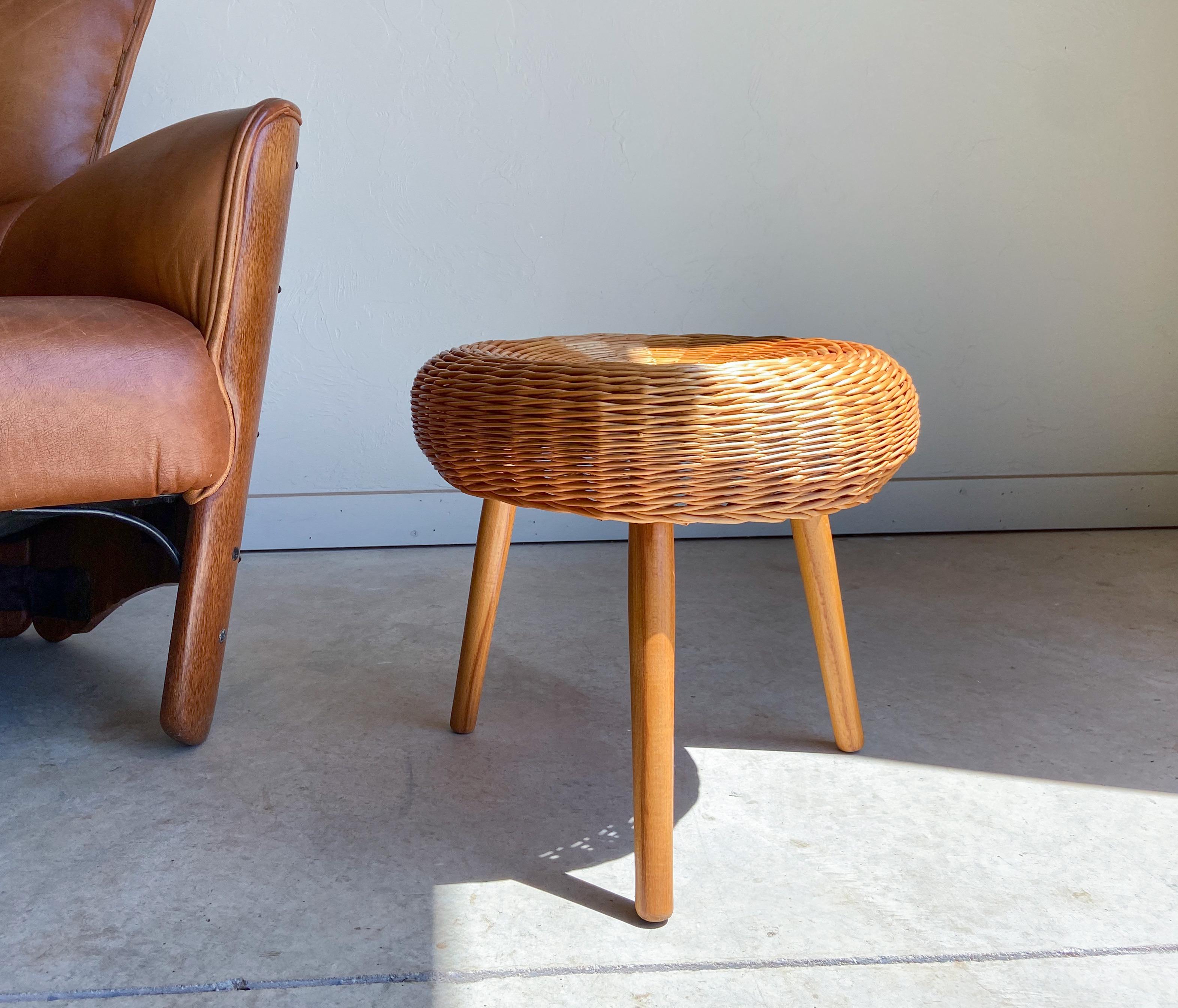 A vintage rattan/wicker and wood stool attributed to Tony Paul.

Featuring a hand woven rattan seat that sits upon a wood frame and solid birch legs.

This would make a perfect accent piece that is suitable in a variety of settings including