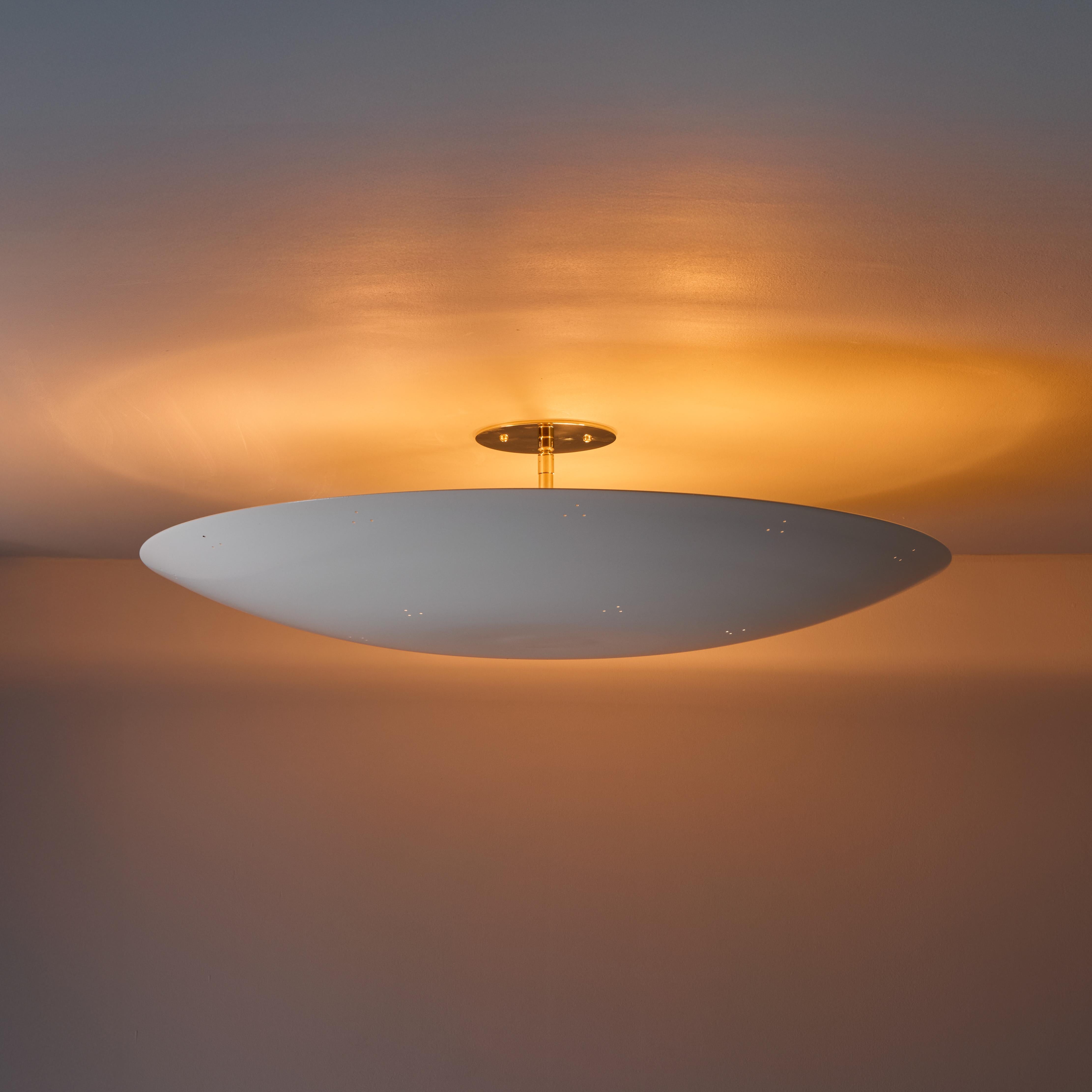 Large Raul Reyes 'Rey 26' perforated dome ceiling lamp in white. Hand-fabricated in Los Angeles, these highly refined ceiling lamps are reminiscent of the iconic mid-century Finnish designs of Paavo Tynell and Lisa Johansson Pape. Executed in white