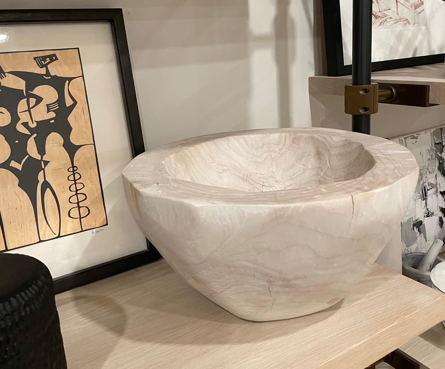 A large sun bleached reclaimed wood bowl. This beautiful hand-carved wood bowl shows off its natural characteristics in a very organic way. The inclusions and cracks are inherent to the reclaimed wood and add beauty to this lovely decorative modern