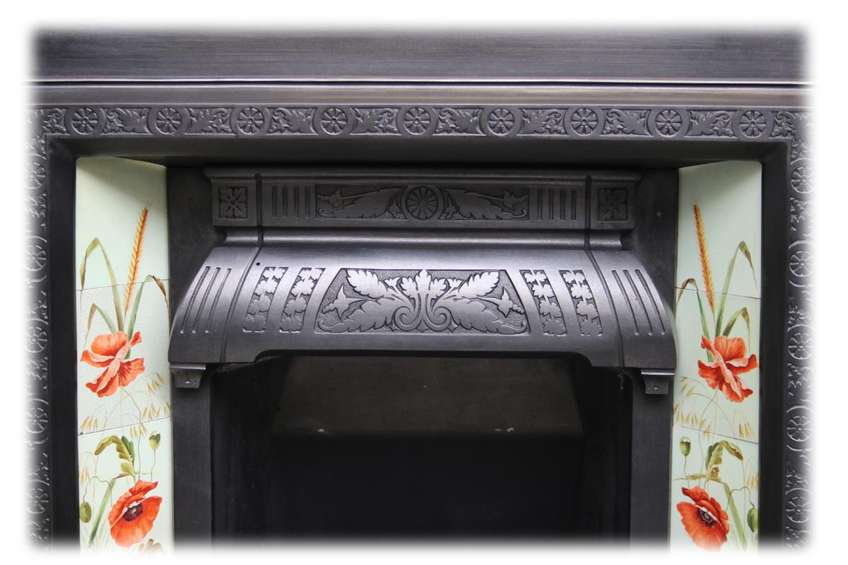 Large reclaimed Victorian cast iron fireplace insert. Dated 1887. 
Complete with a beautiful run of original late Victorian fireplace tiles. Each side hand painted and book matched against the other. Depicting wild flowers including poppies,