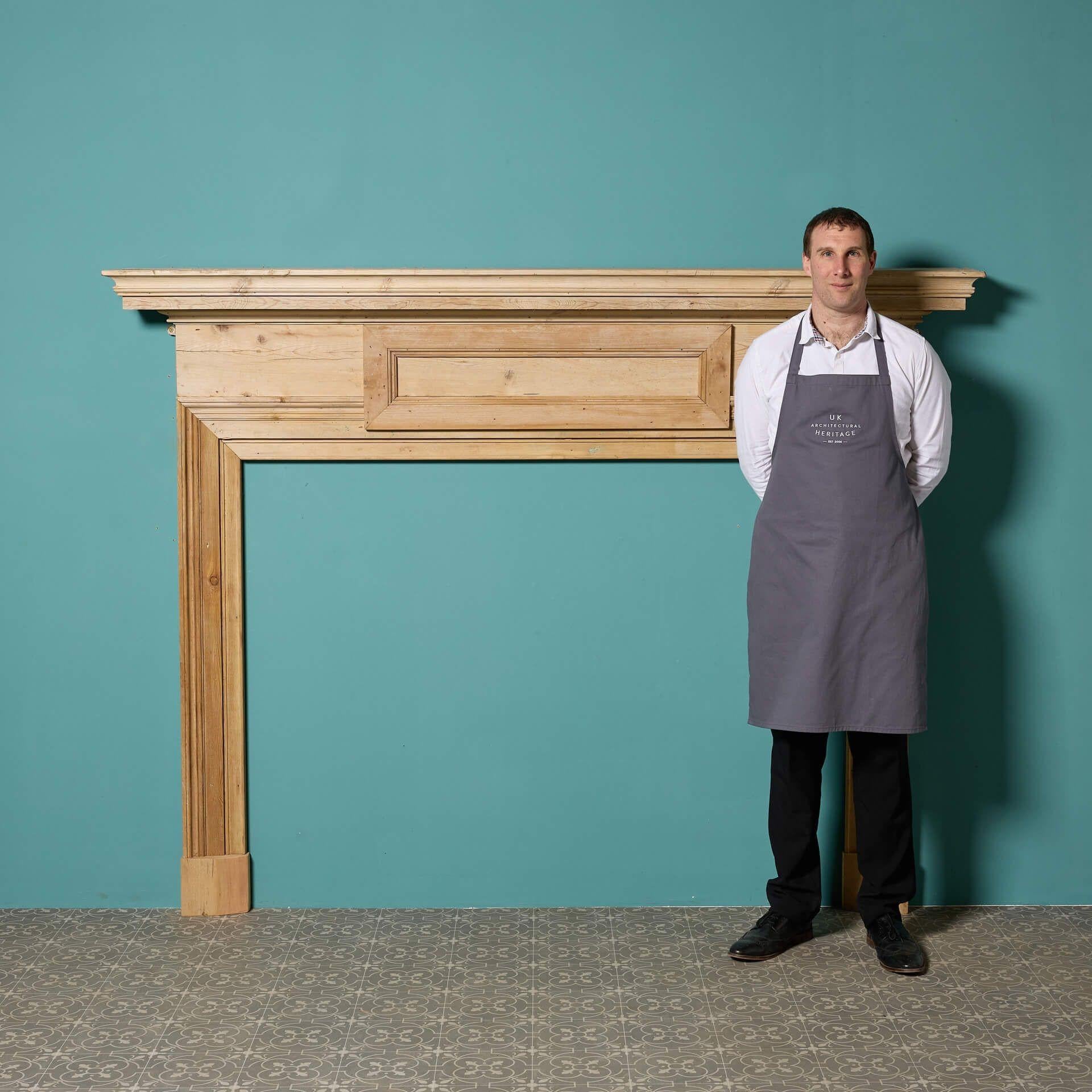 A very large reclaimed pine fire surround in the early Victorian style.

Additional Dimensions 

Opening Height 120 cm

Opening Width 159 cm

Width between outsides of the foot blocks 191.5 cm.