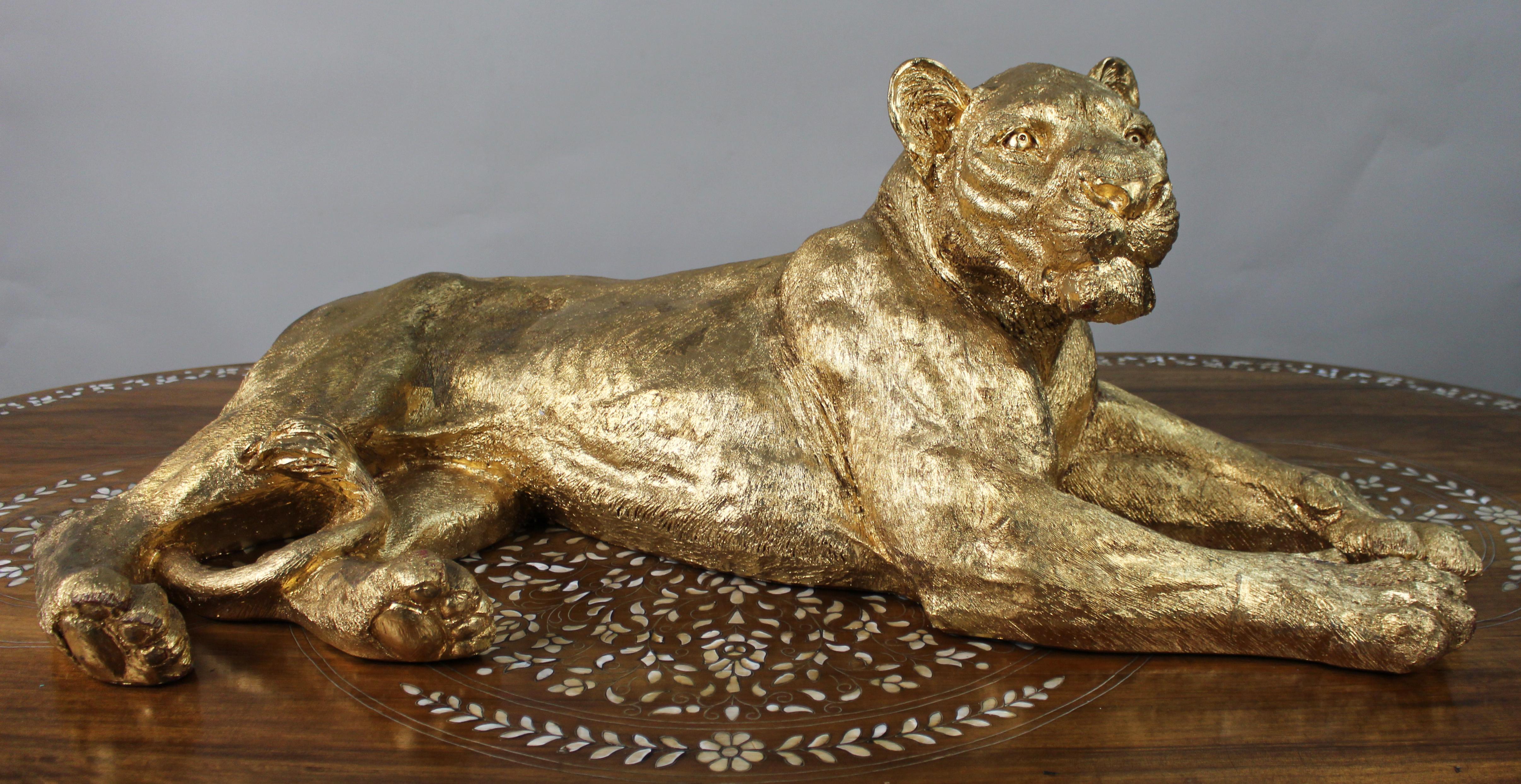 Large Reclining Lioness Sculpture

Hand-Applied Gold Leaf over Resin Body

A striking contemporary sculpture of a reclining lioness, finely modelled and finished with hand-applied gold leaf over a resin body. The figure captures the animal in a