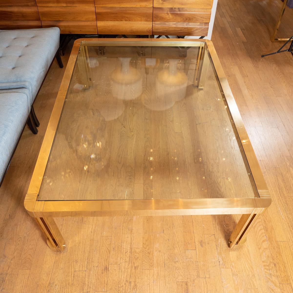 Large rectangular brass and glass coffee table with incised design.
