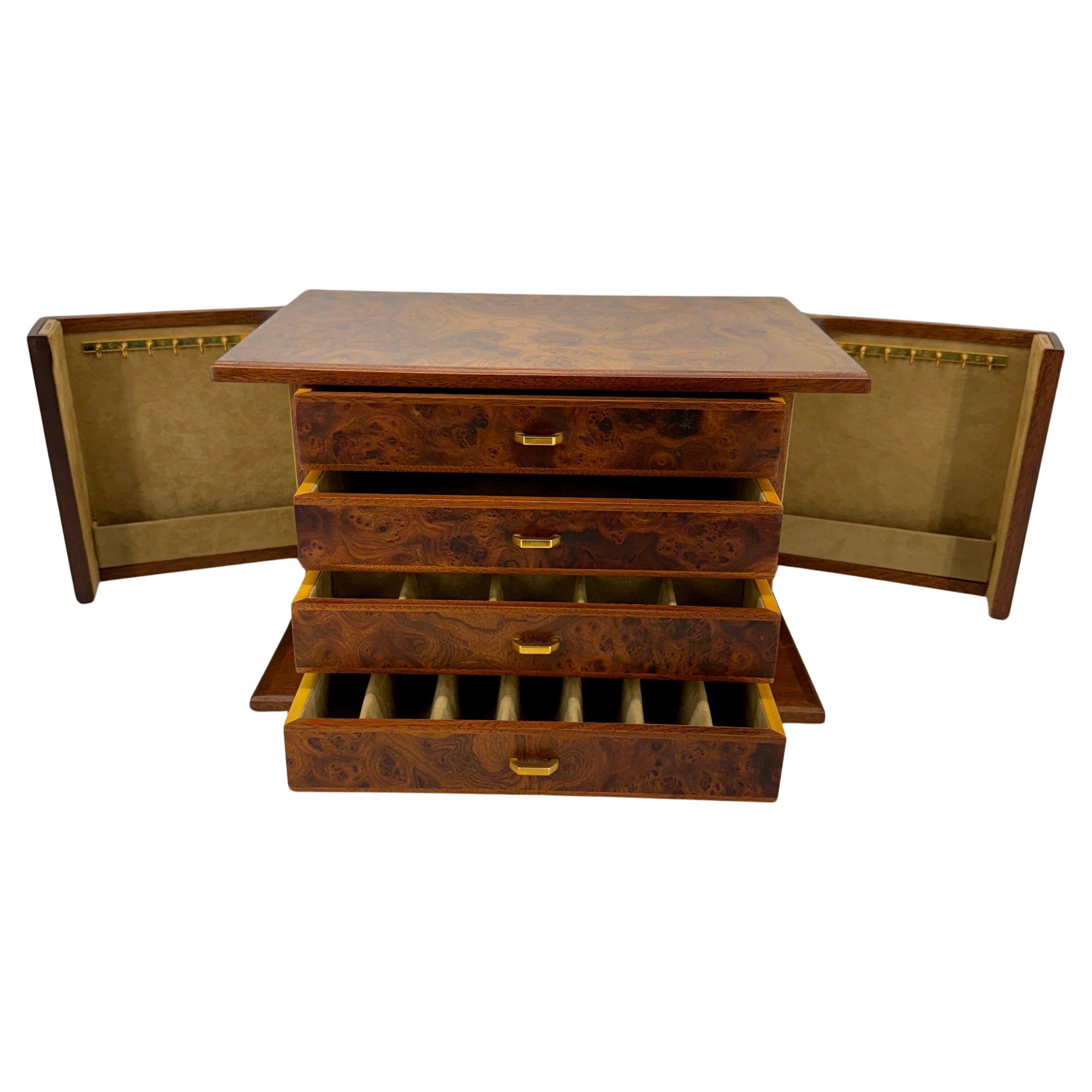 Italian Mid Century Modern Burl Wood Jewelry Box  with Brass Hardware, Marked MADE IN ITALY.
The drawers are for rings and are split into different smalleer size compartments.
This rather large box has two cabinet doors that swings open to reveal