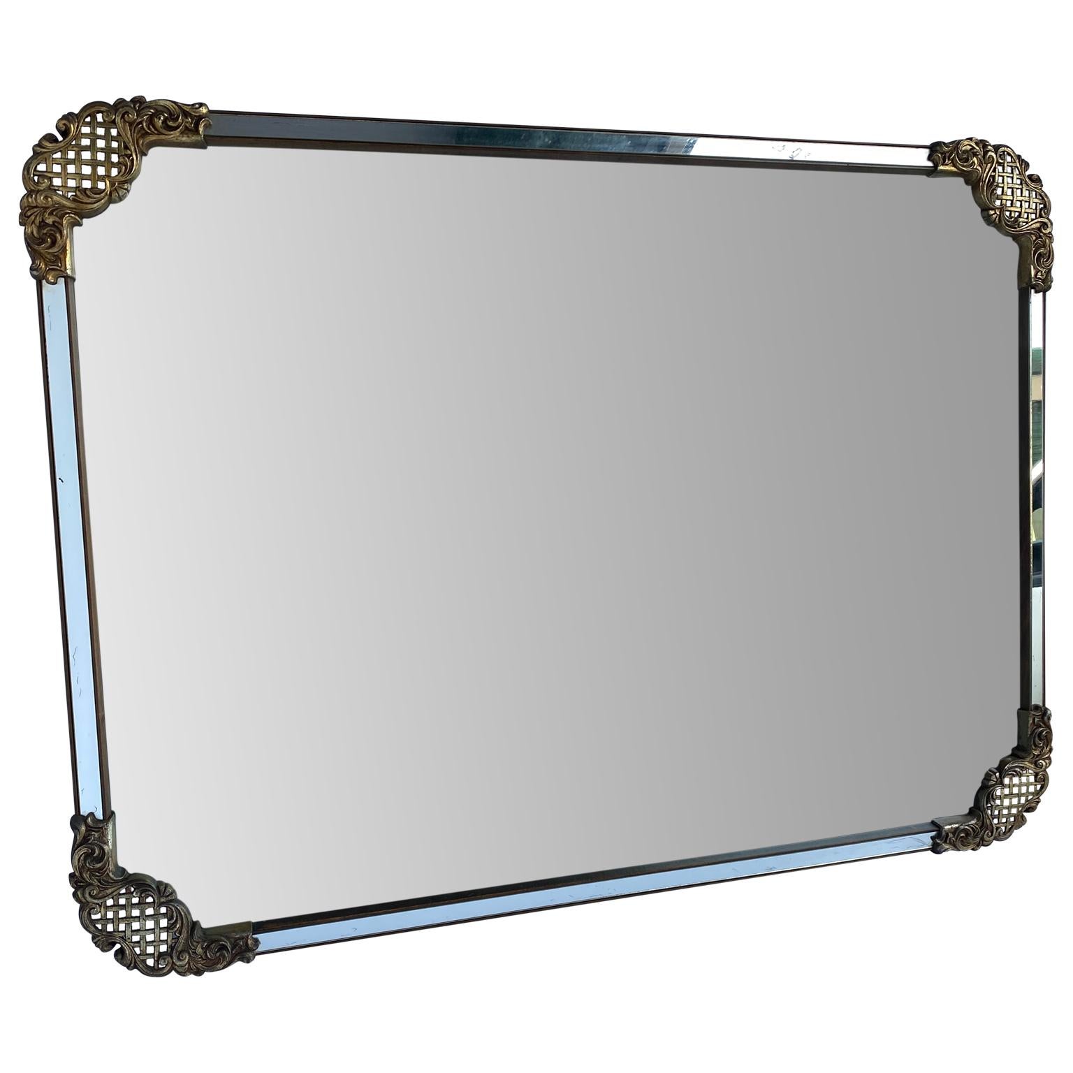 Large rectangular cast iron wall mirror with brass decor on the corners
mirror can hang horizontally or vertically.
 