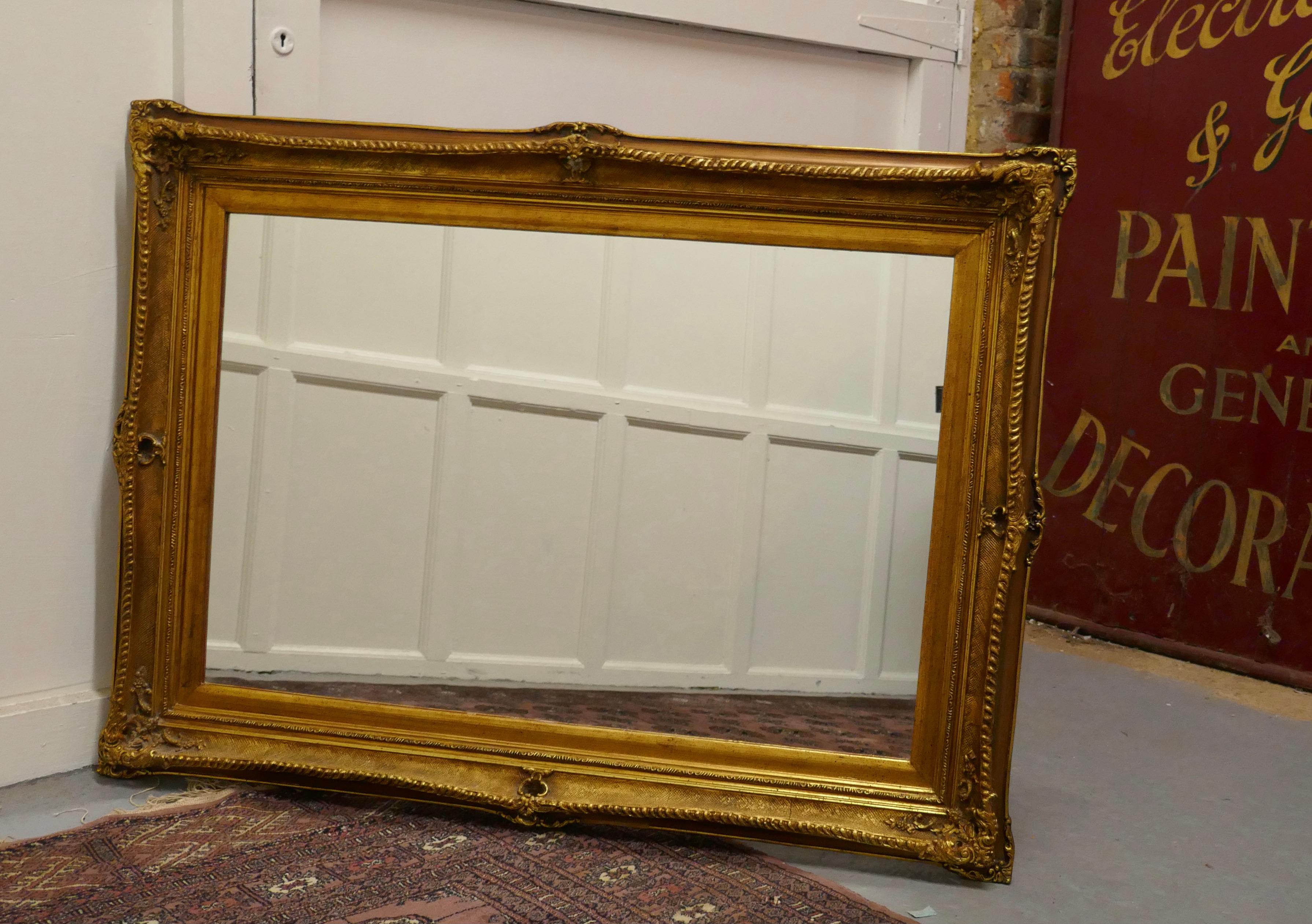 Large rectangular giltwood mirror

The mirror has a 5” wide moulded oval age darkened gilt frame 

The old frame is deeply decorated the looking glass and the back has been replaced with new
The mirror is in good vintage condition and can be