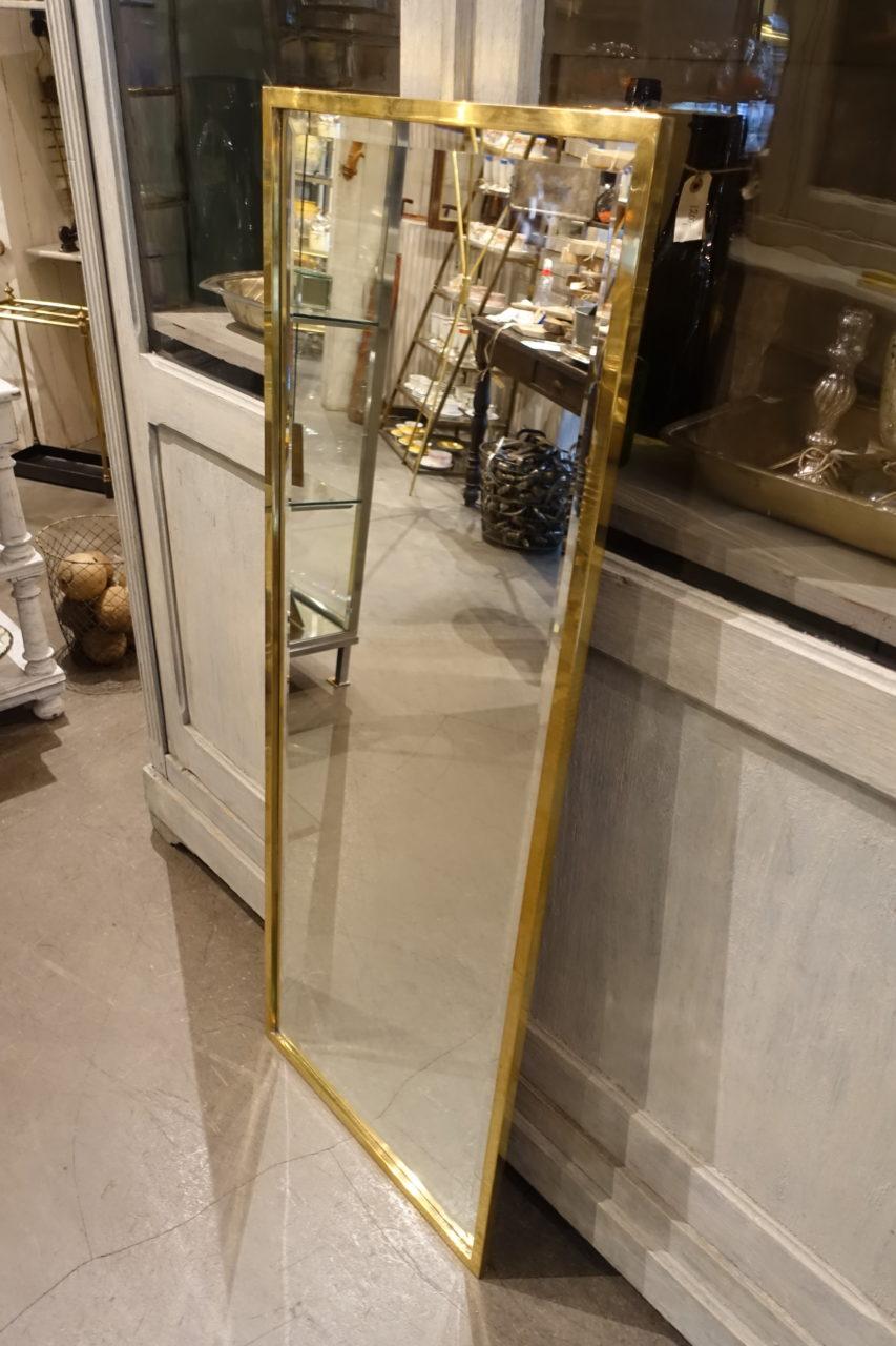 Handsome sizable vintage rectangular Italian midcentury brass mirror. It has a slim brass frame with an elegant profile. Stunning faceted mirrored original glass, and beautiful patina. The mirror can easily be turned either horizontally or