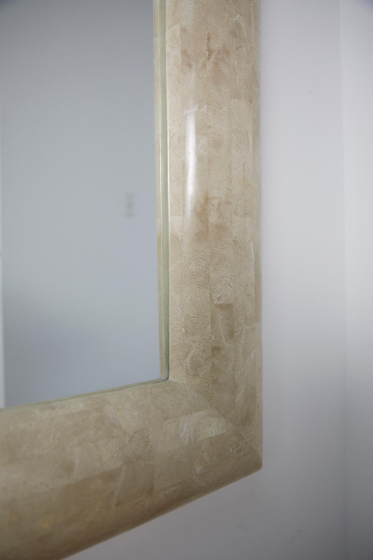 Large rectangular mirror with frame completely covered in inlaid light beige fossil stone. Thick 5