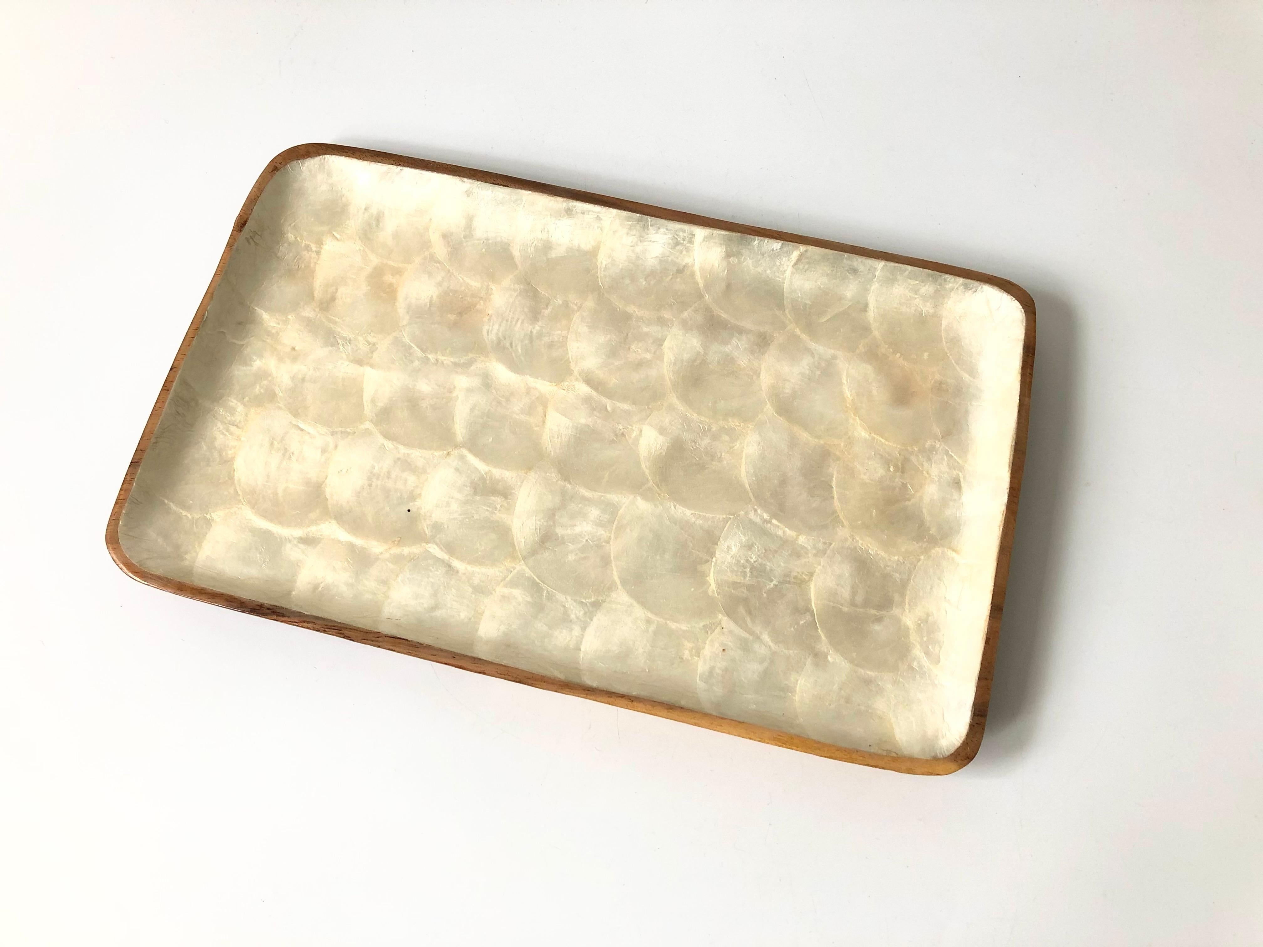 A large vintage rectangular tray. Made of wood, the interior is lined with beautiful semi iridescent capiz shell.
 