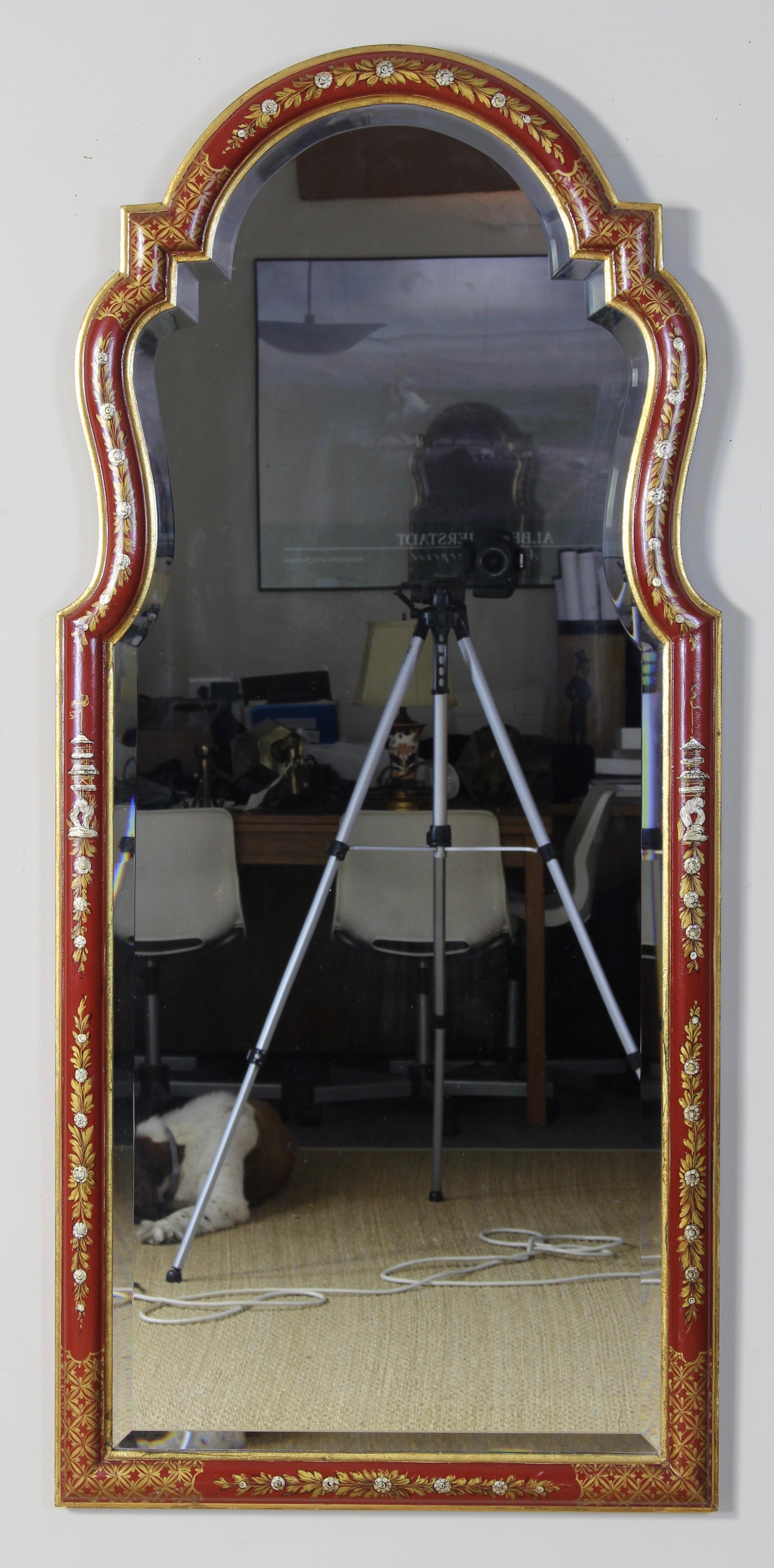 A large late 20th century red chinoiserie decorated Queen Anne style looking glass with beveled inset mirror.