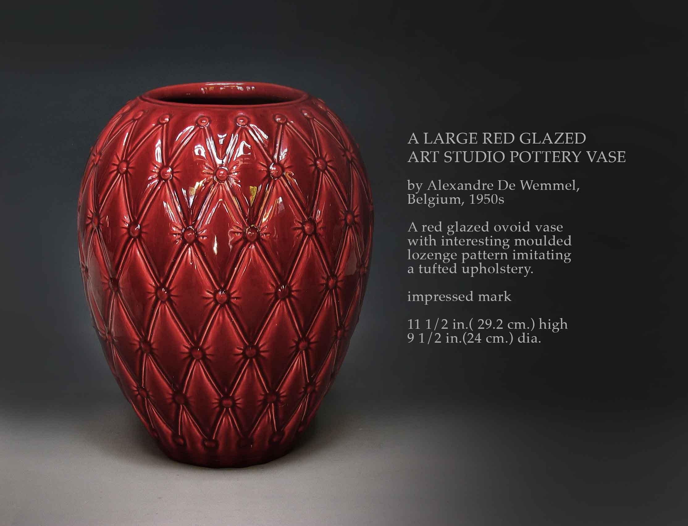 A LARGE RED GLAZED
ART STUDIO POTTERY VASE

By Alexandre De Wemmel,
Belgium, 1950's.

A red glazed ovoid vase
with interesting moulded
lozenge pattern imitating
a tufted upholstery.

Impressed mark.

11 1/2