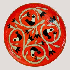 Large red glazed dish with black and green birds by Beatriz Garrigo, 2023