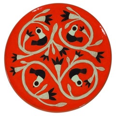 Large red glazed dish with black and green birds by Beatriz Garrigo, 2023
