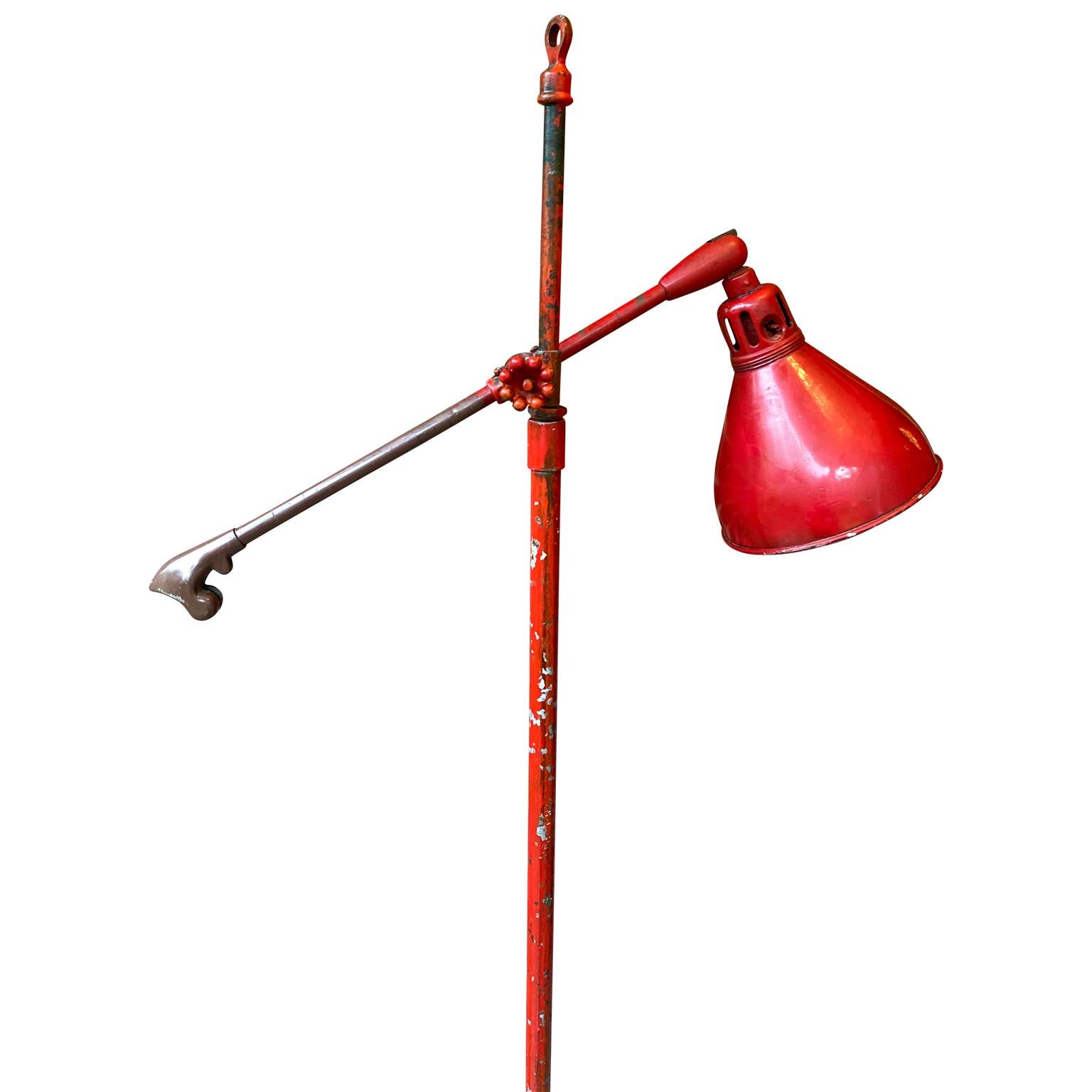 Large adjustable industrial floor lamp featuring the original base.

The iron lamp is painted in red and signed O. C. WHITE ROCHESTER MASSACHUSEETTS.
