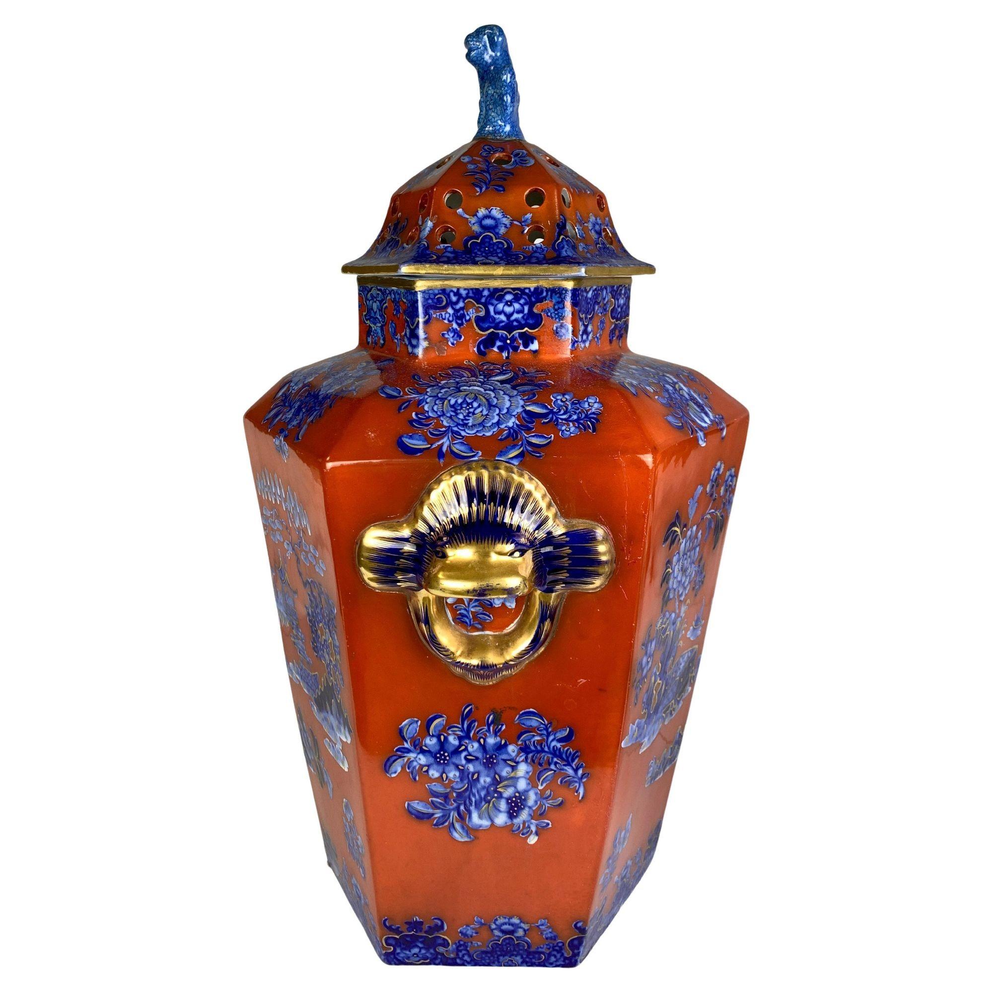 This beautiful jar was made in England during the Regency period, circa 1820. 
The jar boasts a rich deep red enamel ground that contrasts beautifully with the blue chinoiserie decoration.
The combination of rich red and cobalt blue colors is