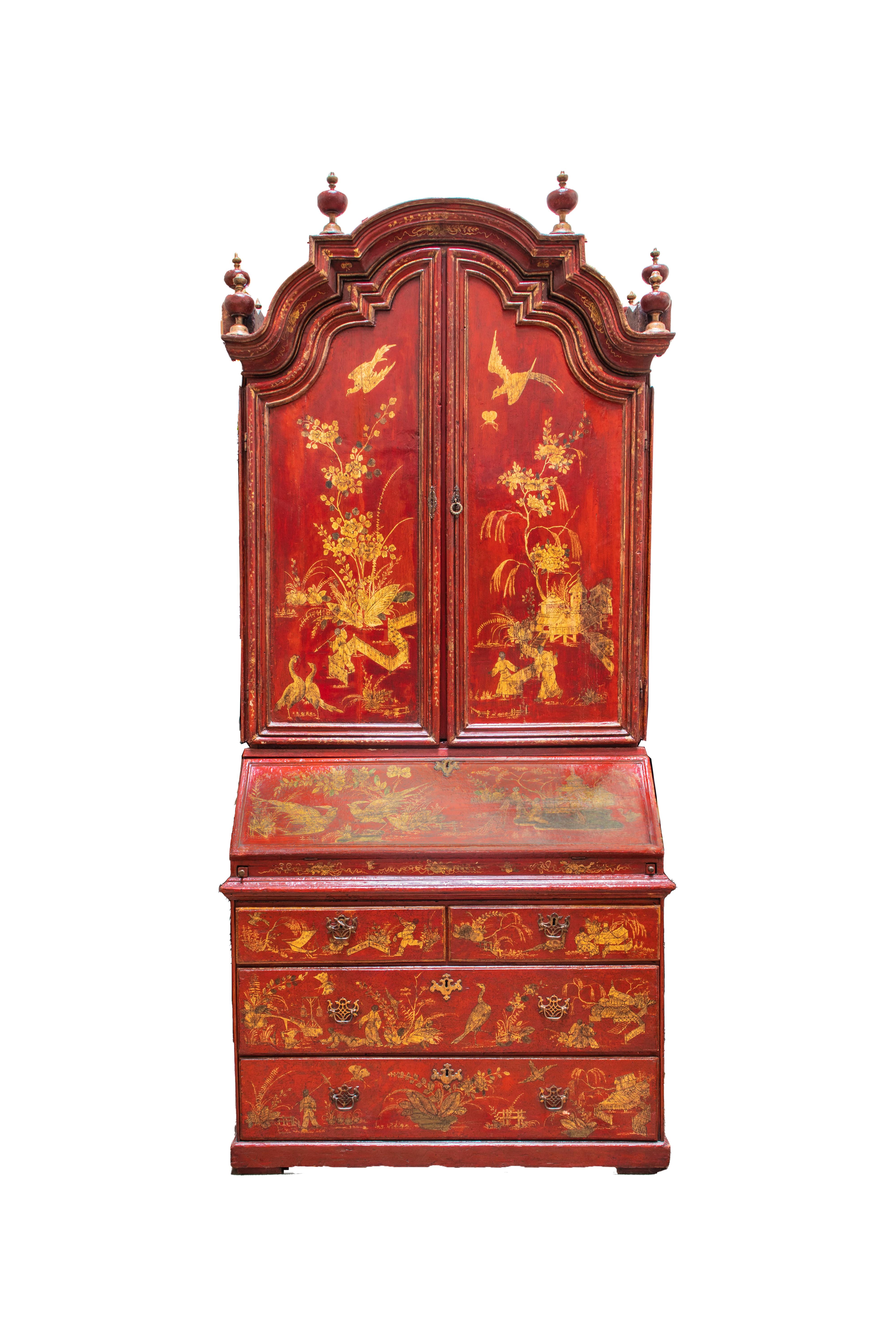 Fine Queen Anne style red Japanned Chinoiserie secretary cabinet. The triple domed top with eight urn finials over two doors, opening interior adorned with hand-painted landscape and floral motifs.  The base with hinged slant lid writing surface