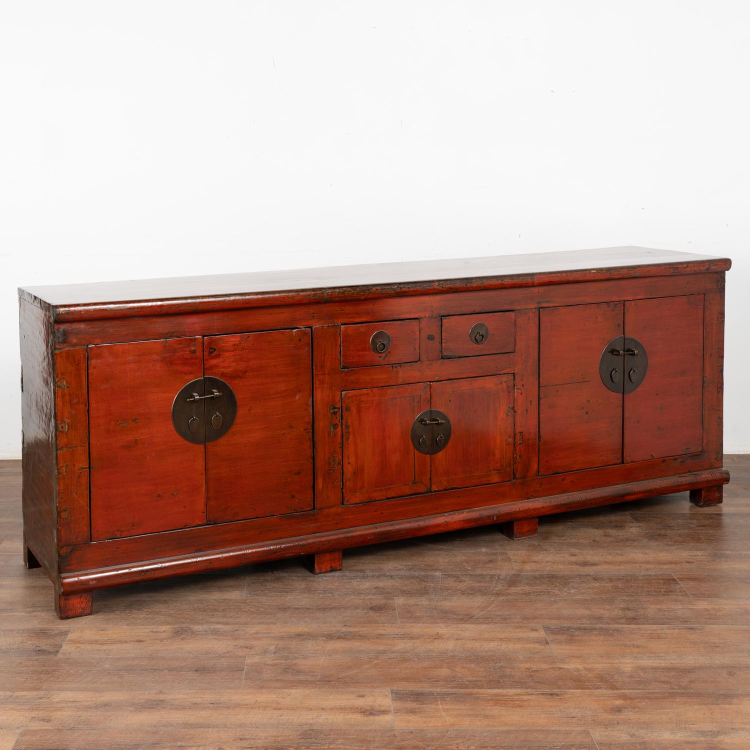 This magnificent sideboard makes an impressive visual statement due to its size (just under 7.5' long) and the remarkable color. It still maintains the original red paint, protected with a traditional lacquer finish. 
Note the placement of drawers