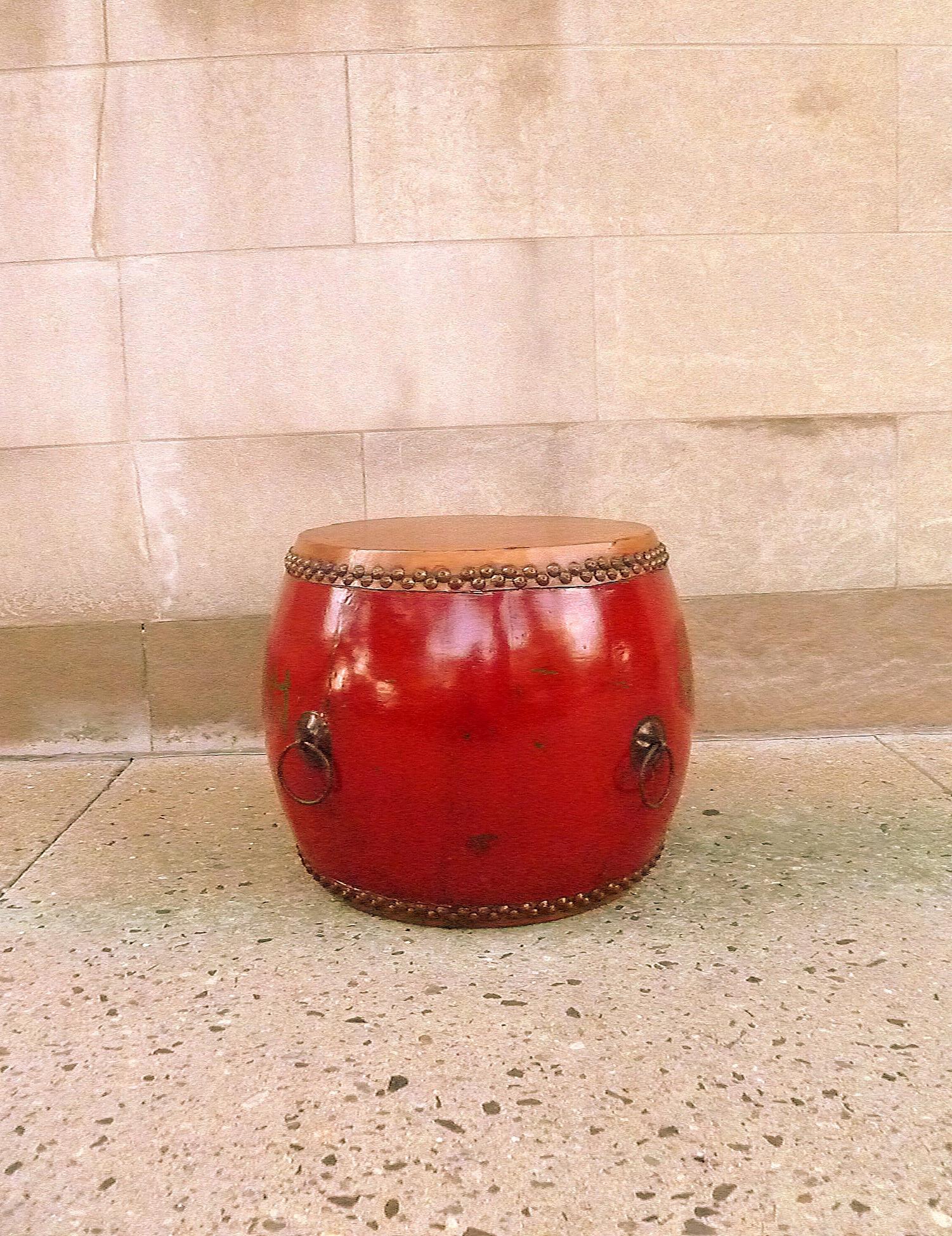 Large red lacquer drum with some painted green Asian characters on the body surface. One of character is 
