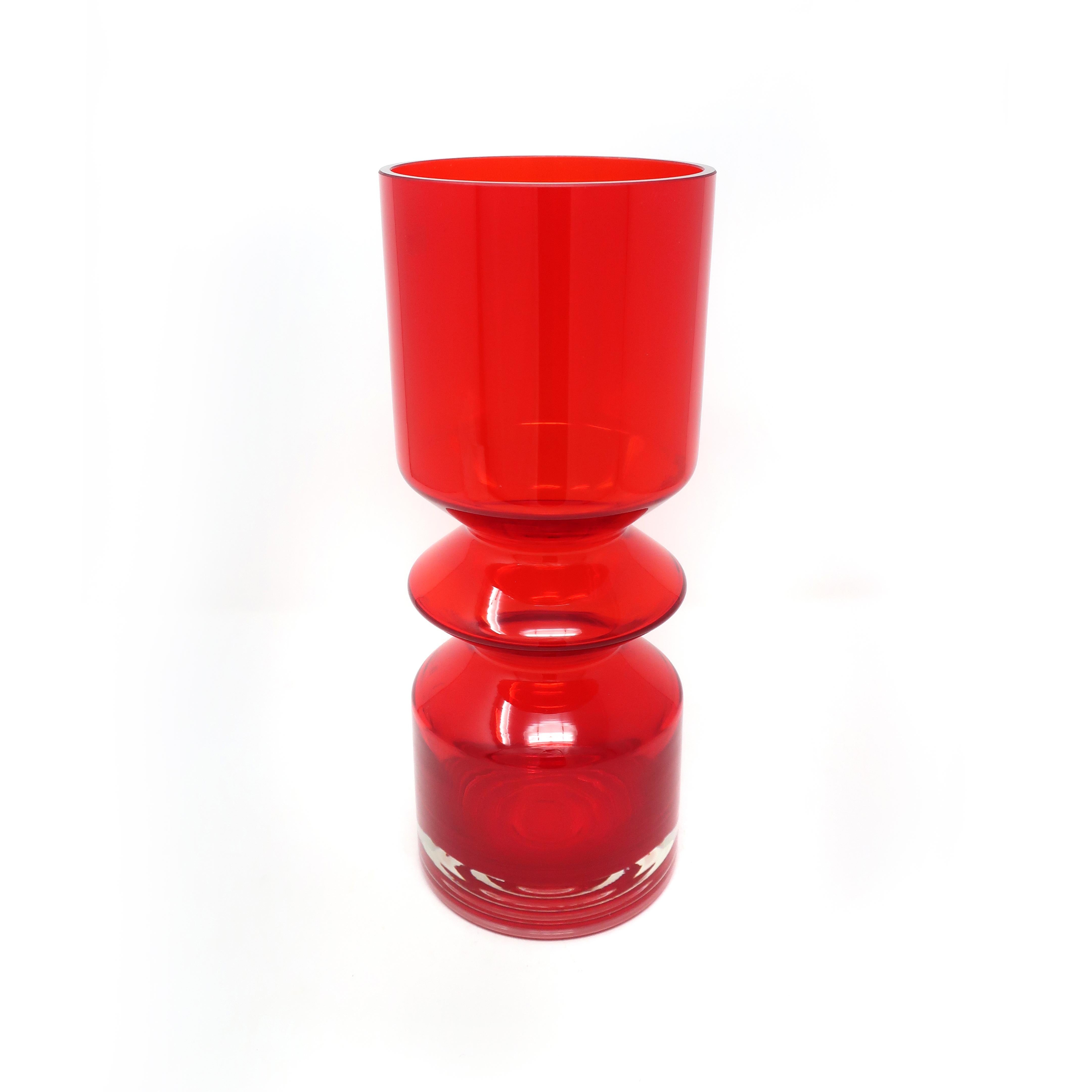 A dazziling large red Finish modernist blown glass vase by Tamara Aladin for Riihimaen Lasi Oy (also referred to as Riihimaki) in a sculptural cylindrical form. In excellent condition with faint remnants of original sticker label.

Measures: 4.5”
