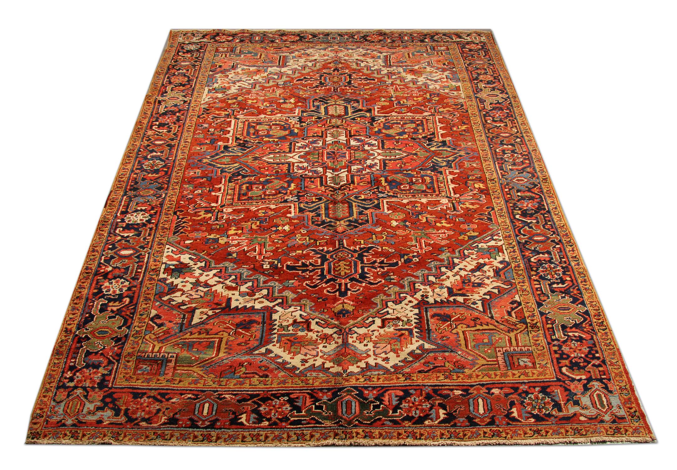 This beautiful wool area rug was constructed by hand in the 1900s and features a fantastic central medallion and surround design. Woven on a red background with an array of colours including blue, green, yellow and blue that make up the delicate