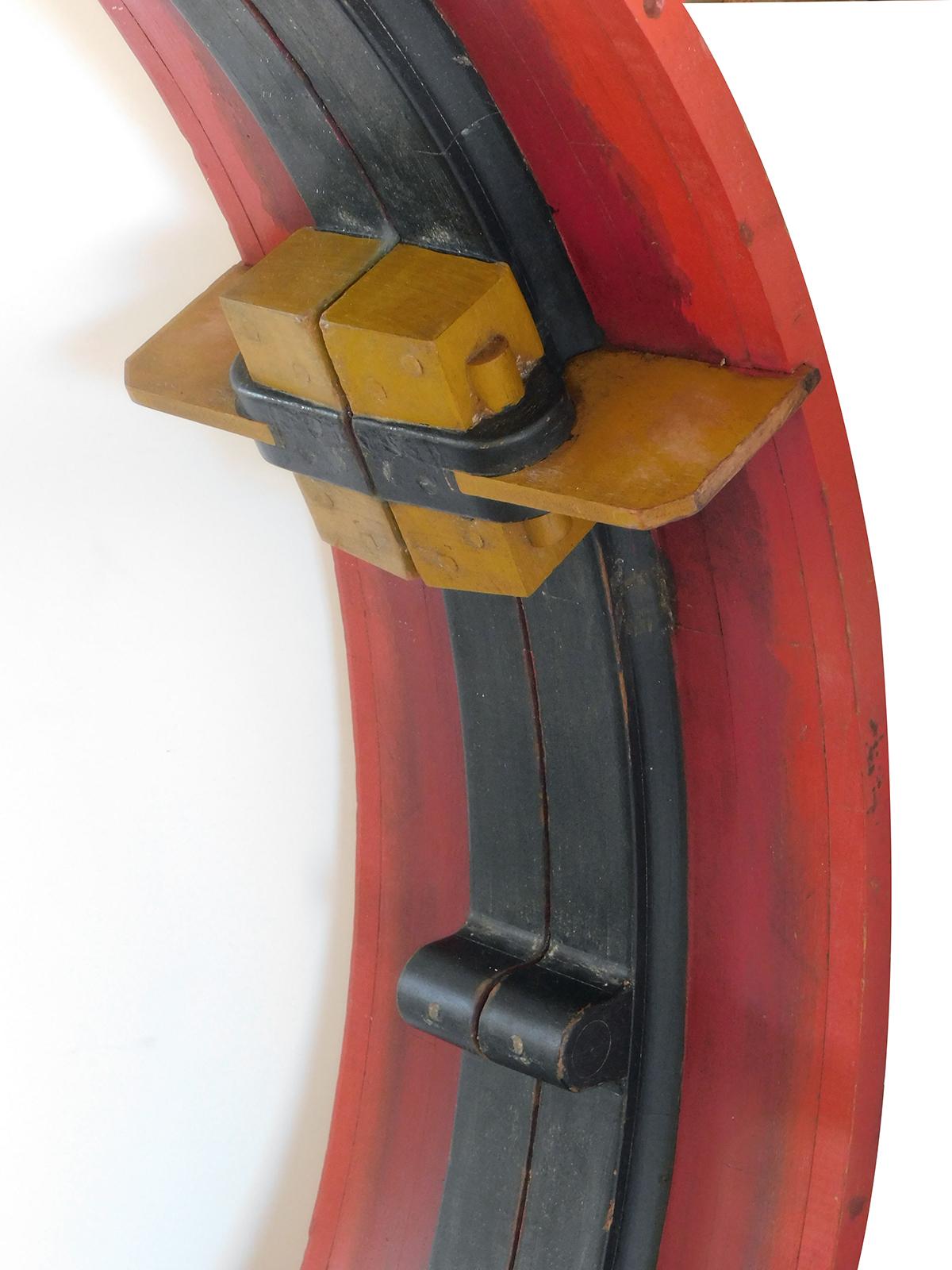 Large vintage painted wood foundry form re-purposed as a mirror; in colors of red, black and mustard