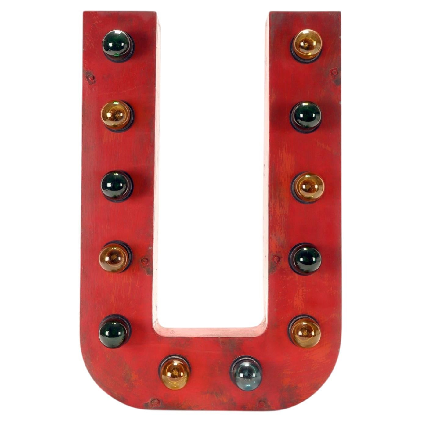 Large red tin letter U illuminated by light bulbs. USA 1930. For Sale
