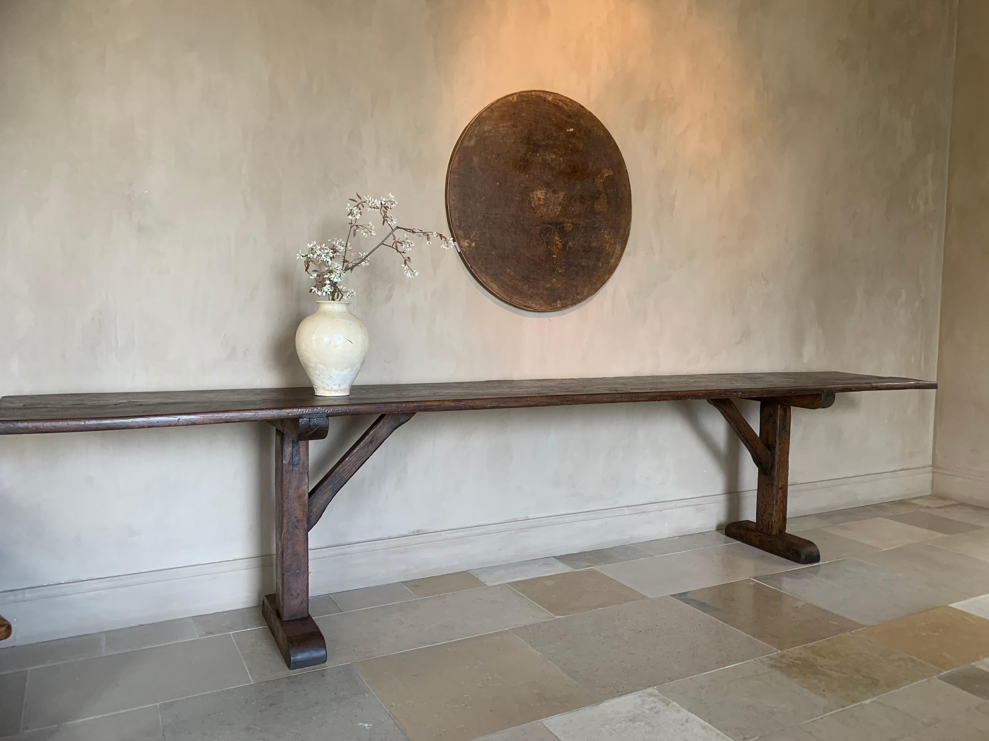 A large 19th century Pyrinee console table. The beautifully patined one slab elm top on softwood trestles. Tables like these were made for centuries in largely the same manner. Knowhow and sense for proportion was handed down for generations.