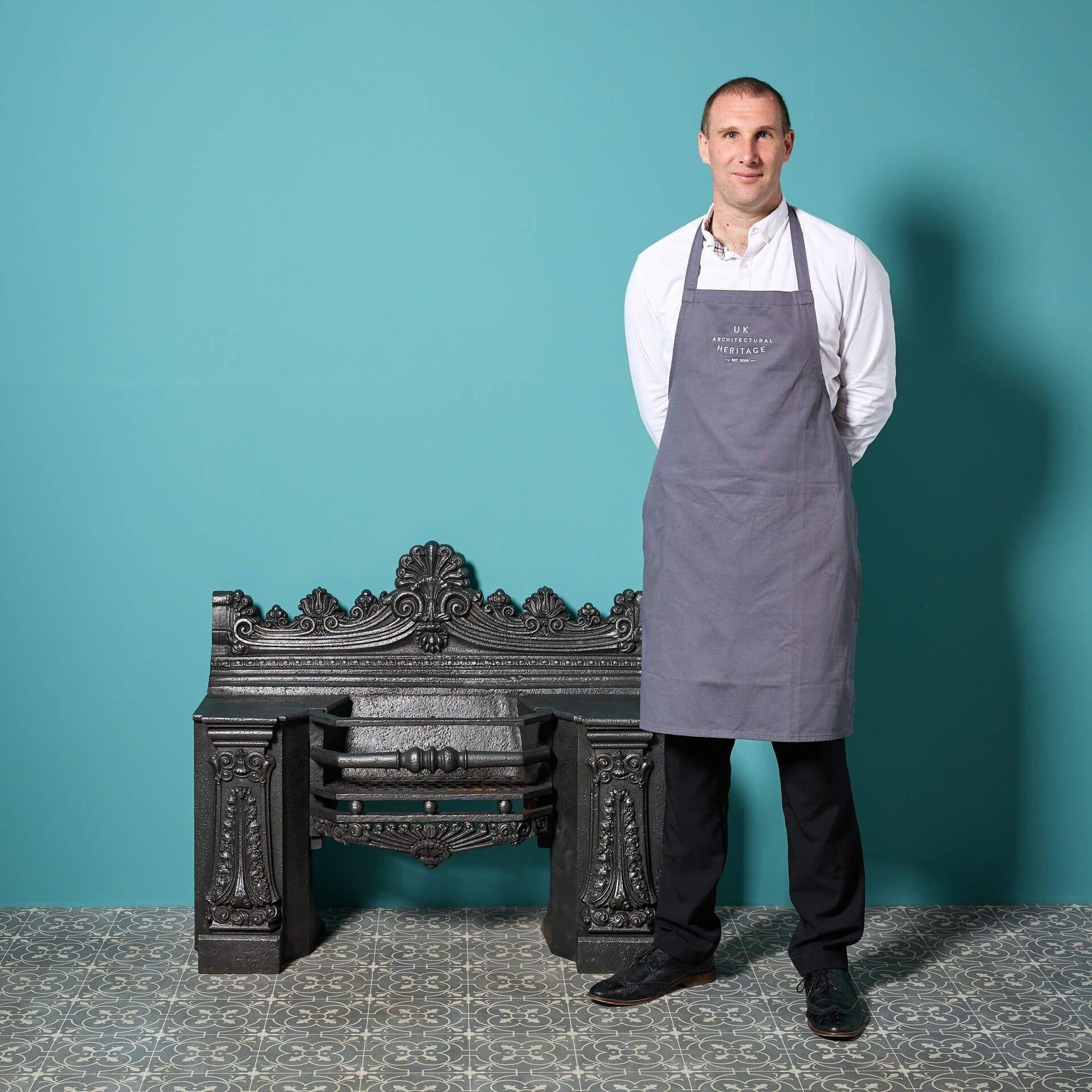 A large regency era cast iron hob grate reclaimed from a house in Hindhead, Surrey. This original cast iron hob grate will work seamlessly with a period fireplace, adding grandeur with its anthemion and scroll motifs.