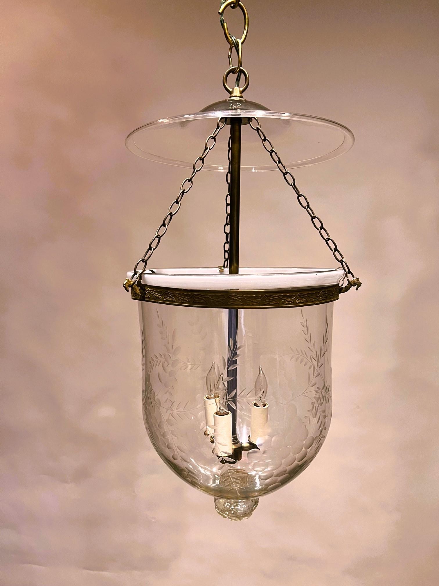 This beautiful hand blown lantern is decorated with hand etched clusters of grapes intertwined with fern fronds. Originally it held a candle; we have electrified it with three candelabra-base sockets to hold 25-watt bulbs at the base of an aged