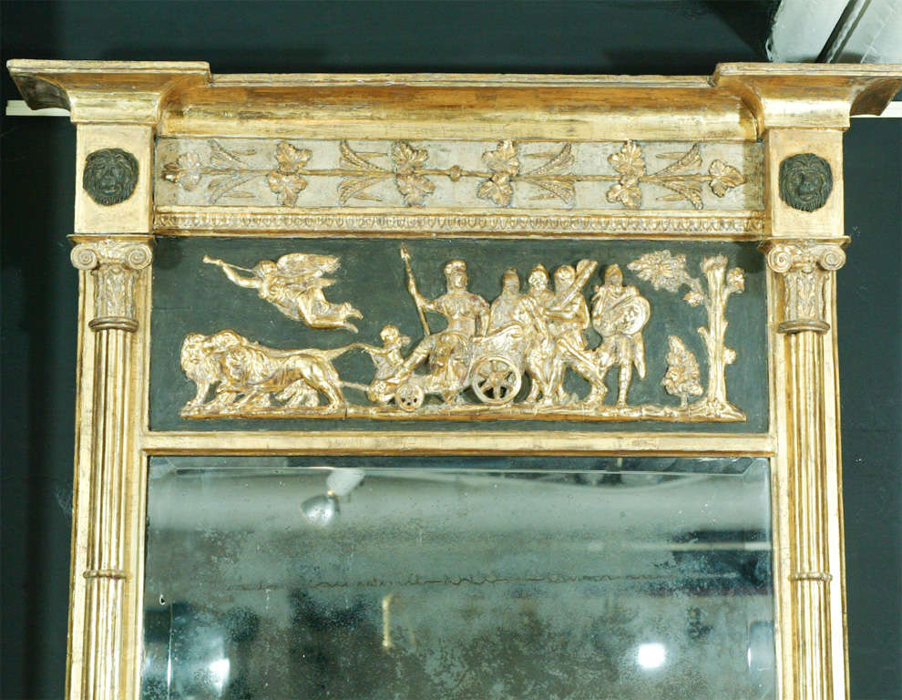 Large Regency carved painted and gilded pier mirror with lion head and ionic column mounts.