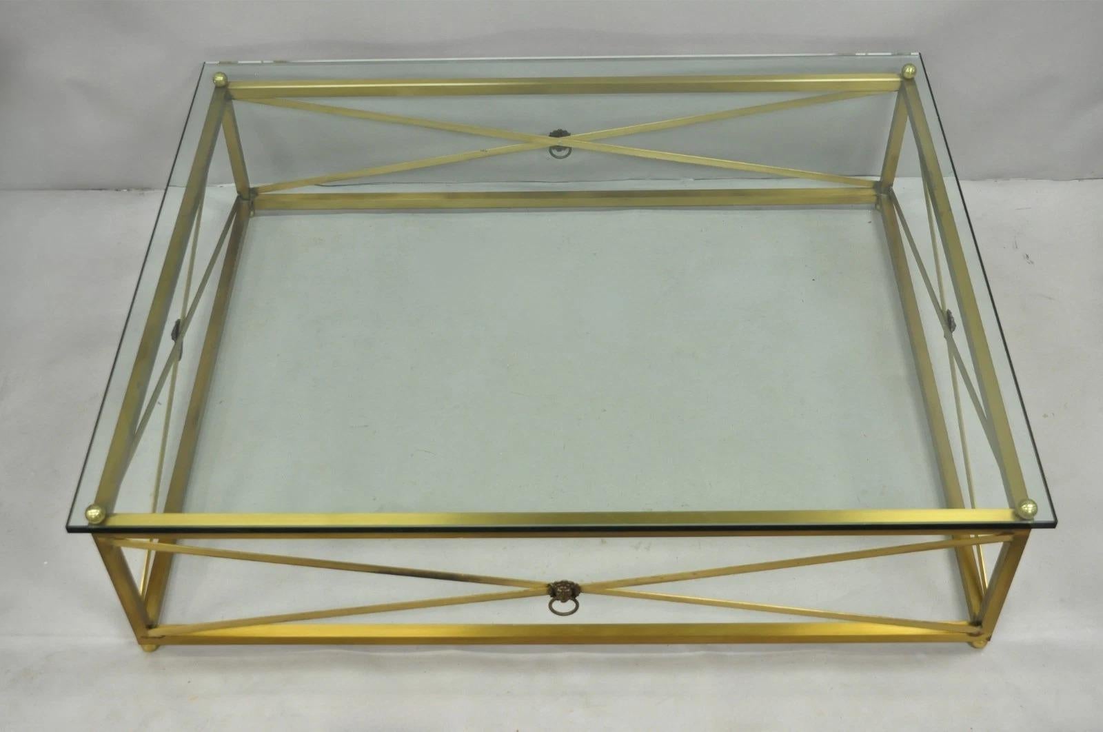 Please message us with your zip code to request a more reasonable domestic U.S. shipping quote.

Large Vintage Regency Style Burnished Brass Rectangular Glass Top Coffee Table w/ Lions Head Drop Pull Accents. Item features a large impressive size,