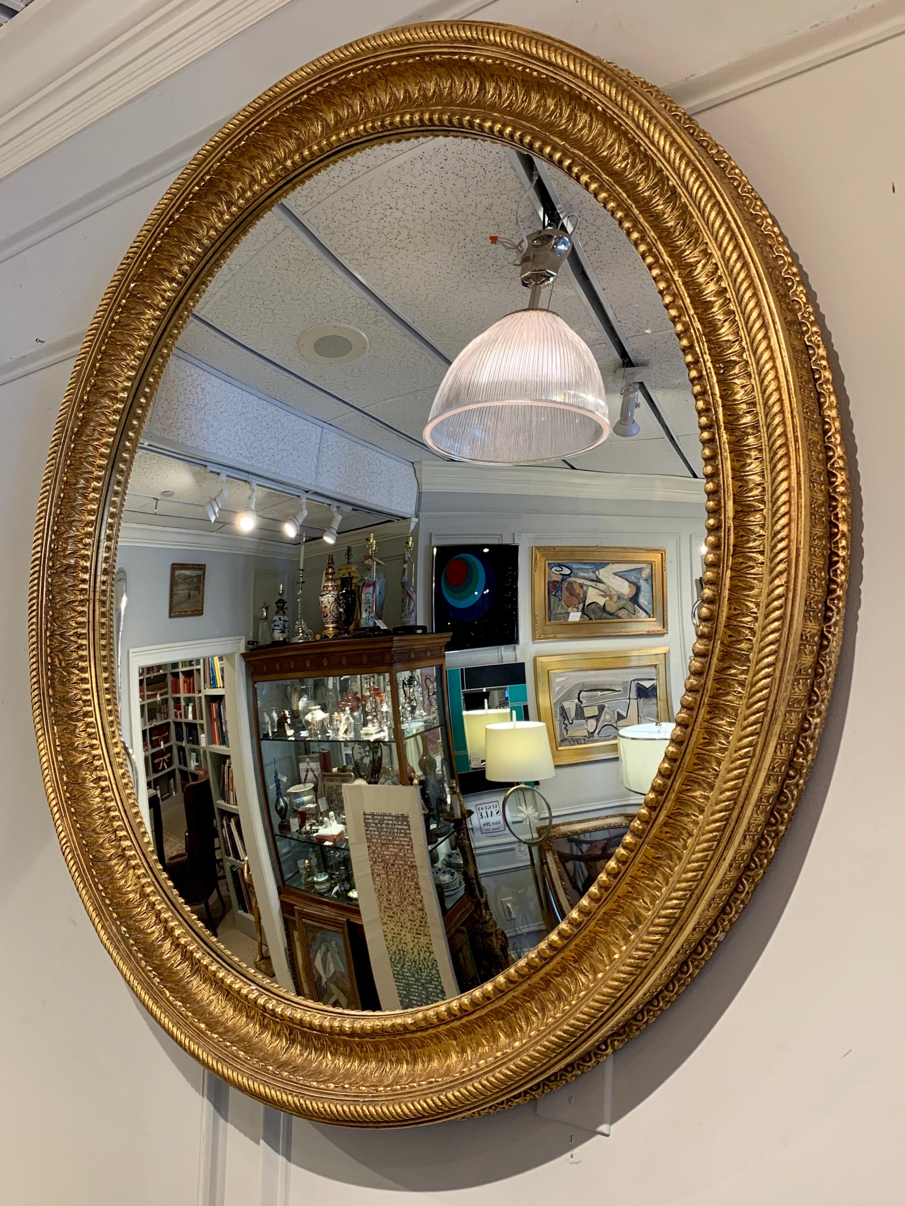 Large Regency style gilt convex mirror, beautifully modeled gilt composition over wood with a 35