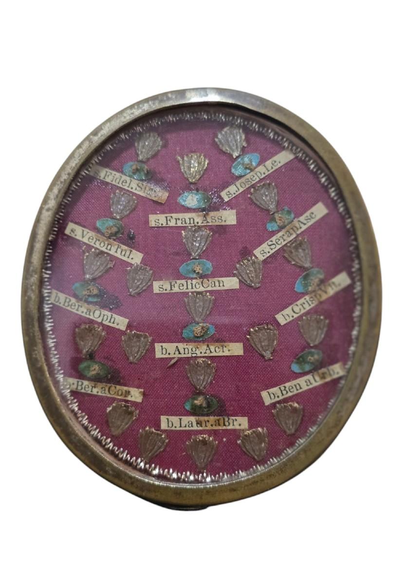 Magnifique reliquaire en métal argenté du XVIIIe siècle, de forme ovale et à l'ornementation soignée. A l'intérieur, elle abrite de nombreuses reliques de saints, soigneusement disposées et protégées par des vitraux d'époque. Le reliquaire conserve